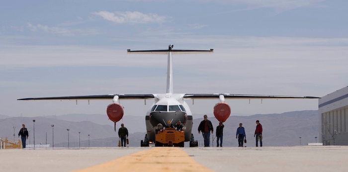 The Advanced Composite Cargo Aircraft rolls out of a hangar in May at Lockheed Martin's Skunk Works plant in Palmdale, Calif. The ACCA is a modified Dornier 328J aircraft. The fuselage aft of the crew station and the vertical tail were removed and replaced with completely new structural designs made of advanced composite materials fabricated using out-of-autoclave curing. Air Force Research Laboratory officials at Wright-Patterson Air Force Base, Ohio, oversee the ACCA program. (Courtesy photo) 
