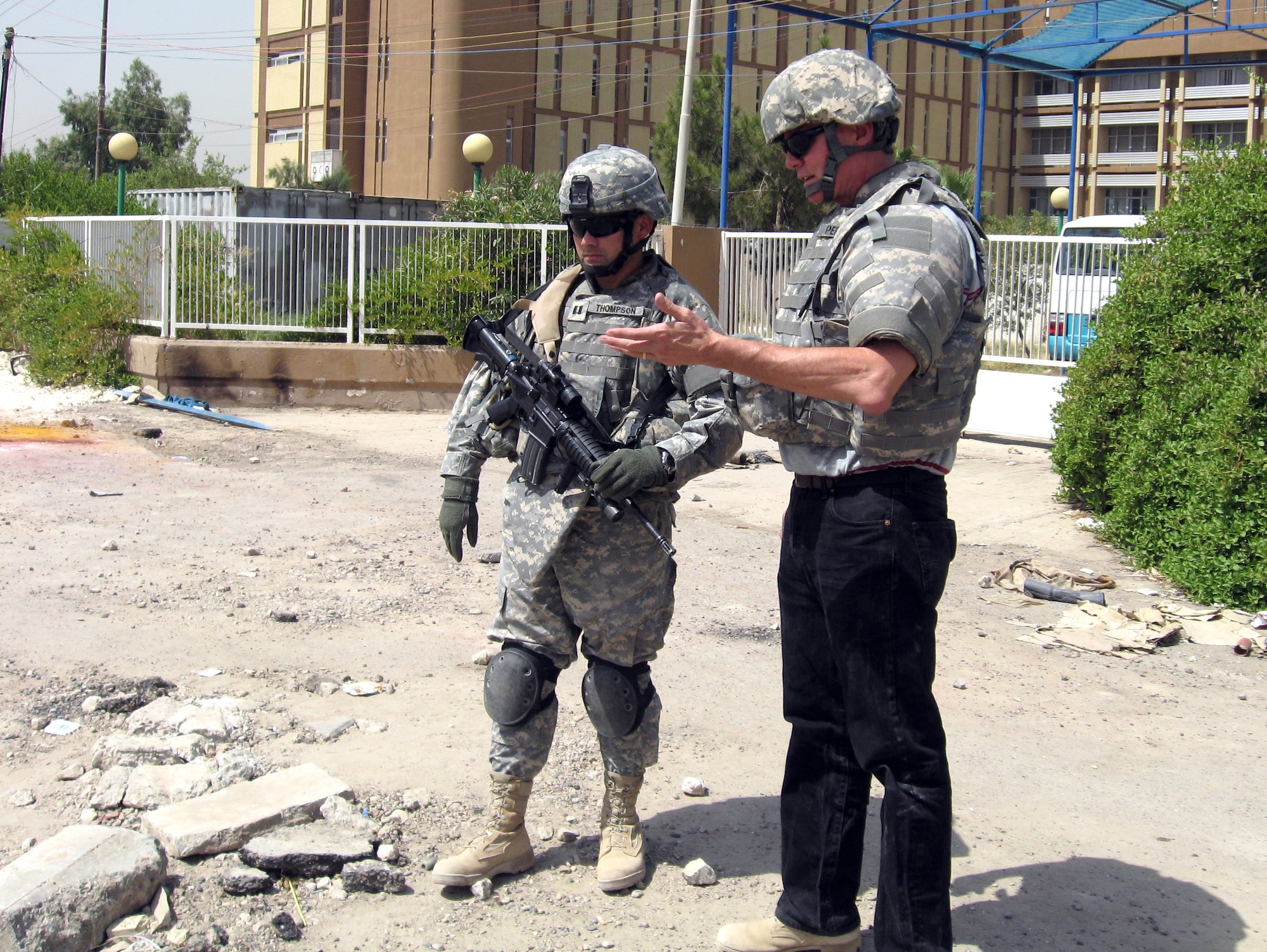Bob Perry and Capt. Christian Thompson assess the damage done to a high voltage electrical line while deployed in support of Operation Iraqi Freedom in July 2007.  The line, which leads to a children's hospital, was damaged by an improvised explosive device. Earlier this year, Air Force senior leaders outlined their vision for supporting Department of Defense civilians to serve in global expeditionary positions through a program called the Civilian Expeditionary Workforce. (Courtesy photo) 