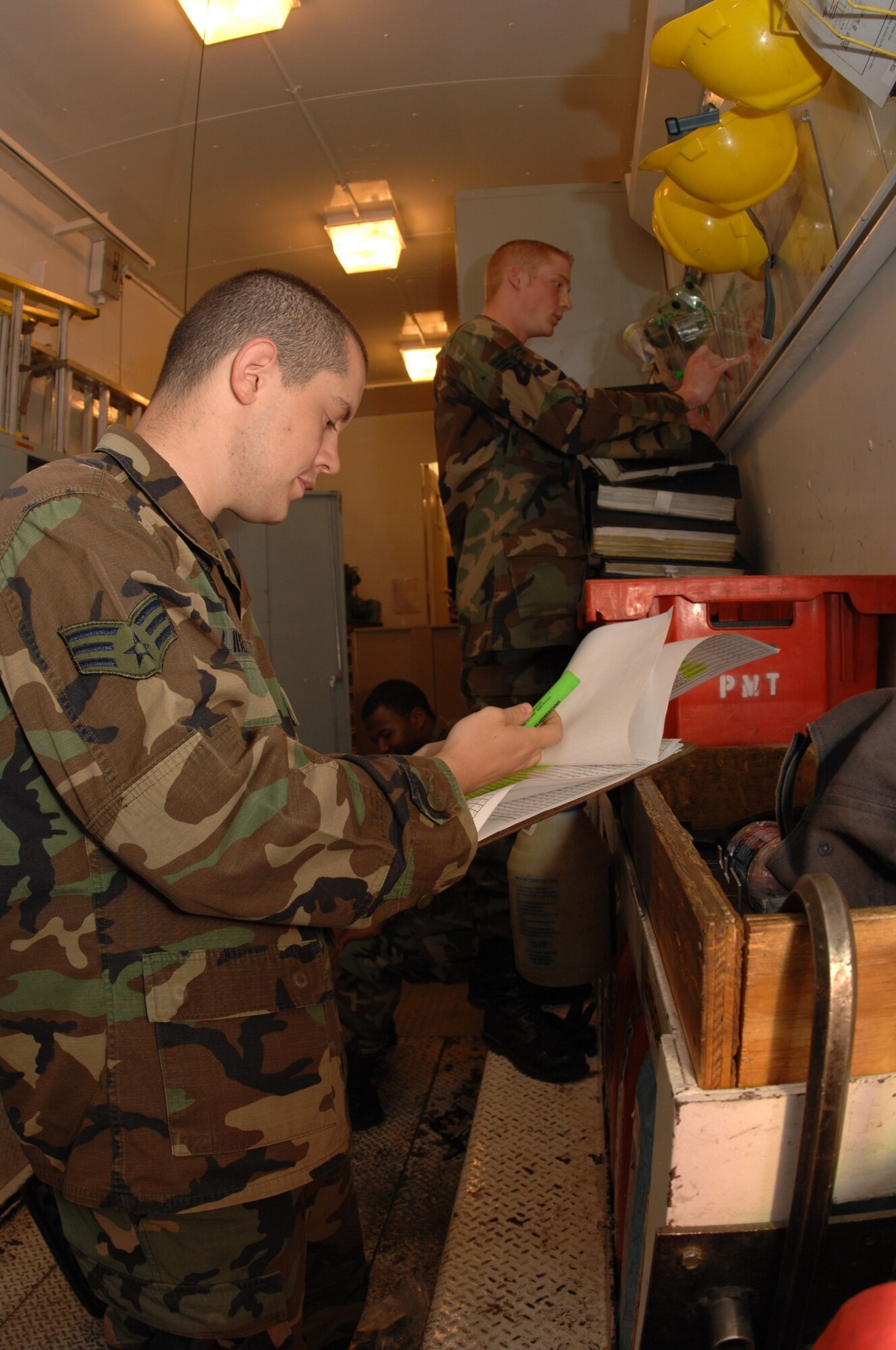 MINOT AIR FORCE BASE, N.D. -- Senior Airman Keith Liberty (front), Senior Airman Michael Swain, and Airman 1st Class Darrell Willis work on getting all the tools and components ready for the exercise and field operations here May 28.  Airmen from the 91st Missile Maintenance Squadron are responsible for providing maintenance and logistics support for the 91st Missile Wing. (U.S. Air Force photo by Staff Sgt. Angel Gallardo)