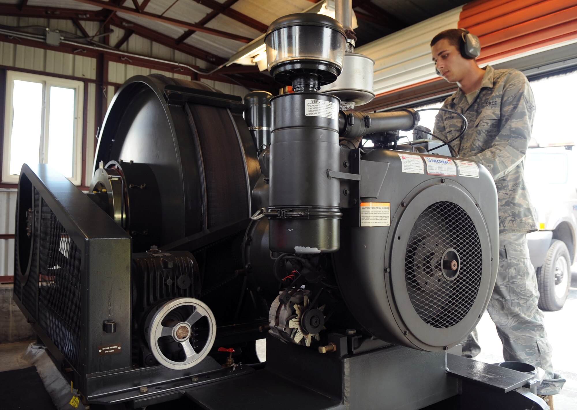 Airman 1st Class David Spahn demonstrates how to operate the aircraft arrest system on Charleston AFB’s flightline May 29. The system employs a cable line which catches arresting hook-equipped jets during emergency landings, a critical runway asset subject to inspection during the upcoming Air Traffic System Evaluation Program visit. Airman Spahn is a barrier maintenance technician with the 437th Civil Engineer Squadron. (U.S. Air Force photo/Airman Ian Hoachlander)