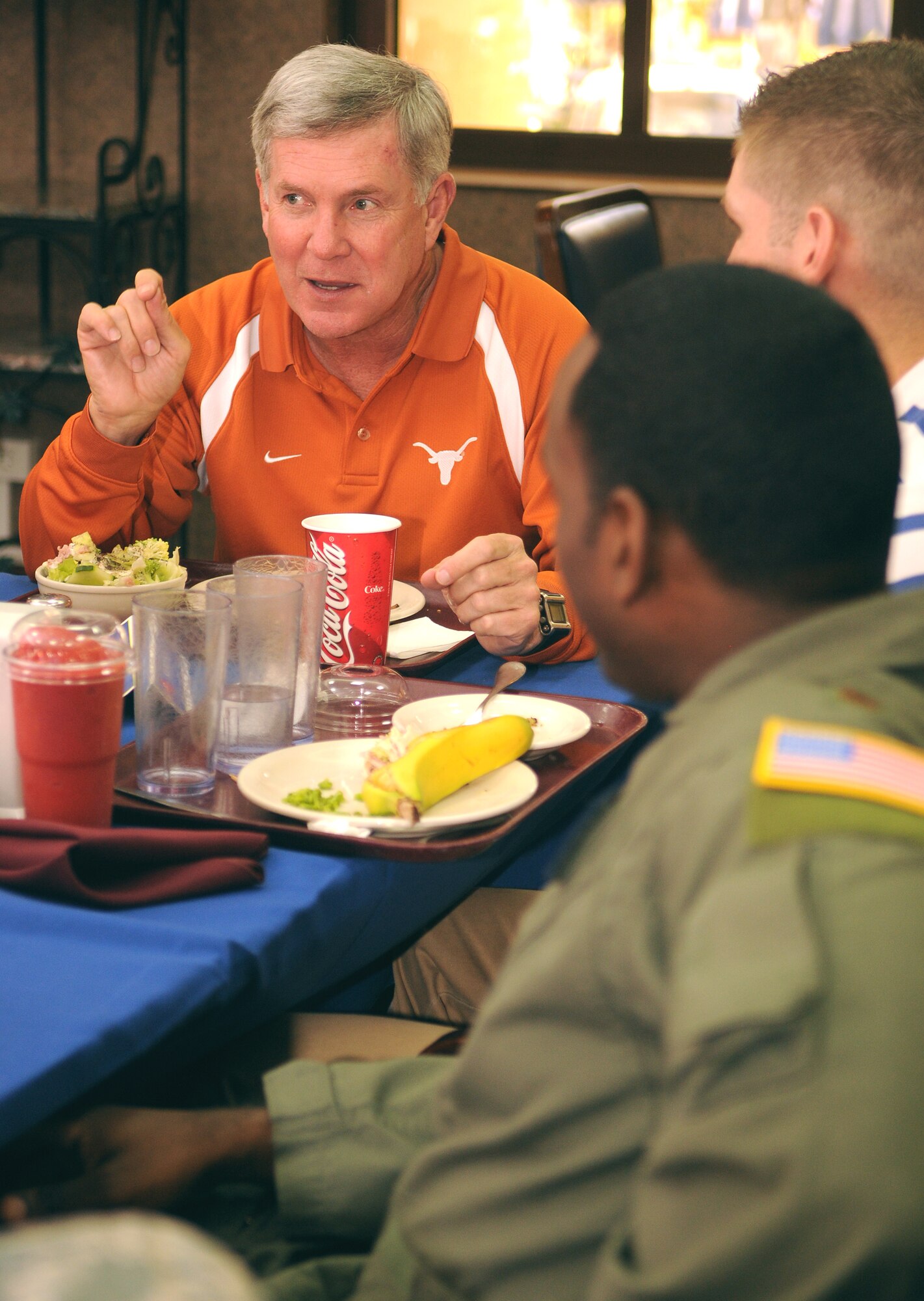 University of Texas head football coach Mack brown speaks and dines with Maj. John-Michael Calhoun, 817th Expeditionary Airlift Squadron, and other Longhorn fans during a luncheon Saturday, May 30, 2009 at the Sultan Inn here. The luncheon was part of the Armed Forces Entertainment Coaches Tour. Coach Brown was the NCAA’s 2008 coach of the year. (U.S. Air Force photo/Airman 1st Class Alex Martinez)