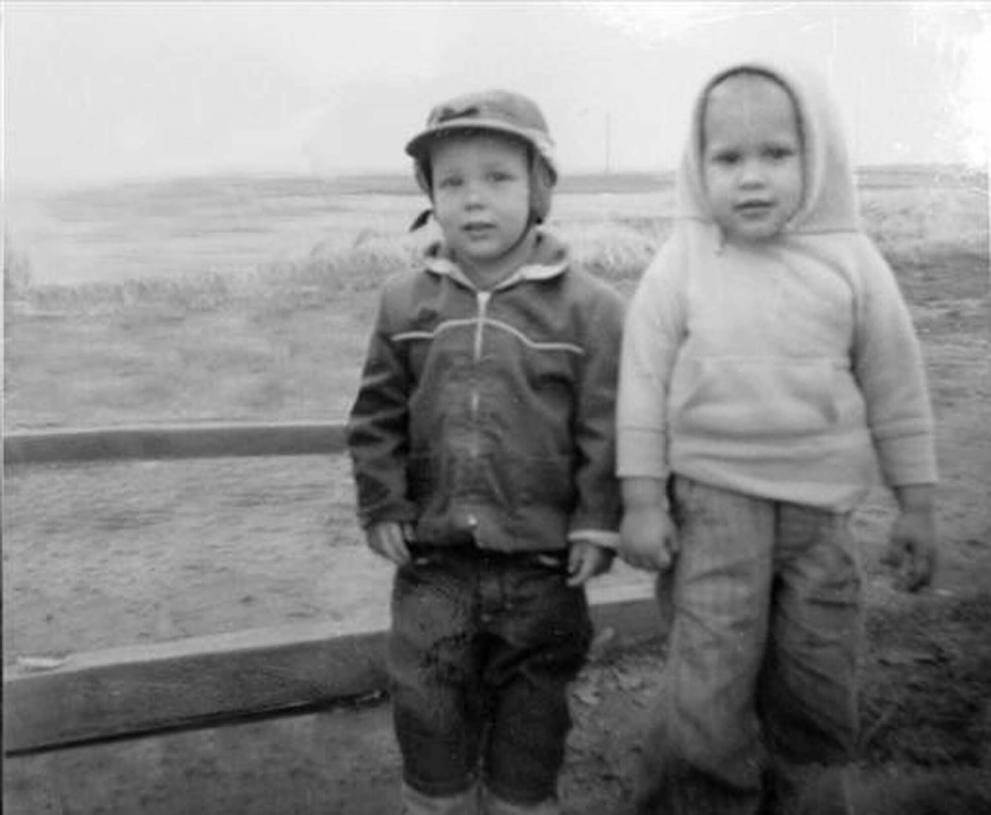 Jeffrey Dunn (left) and Brian Bishop pose next to the sandbox they played in at Mather Air Force Base, Calif., in the spring of 1963. (Courtesy photo)