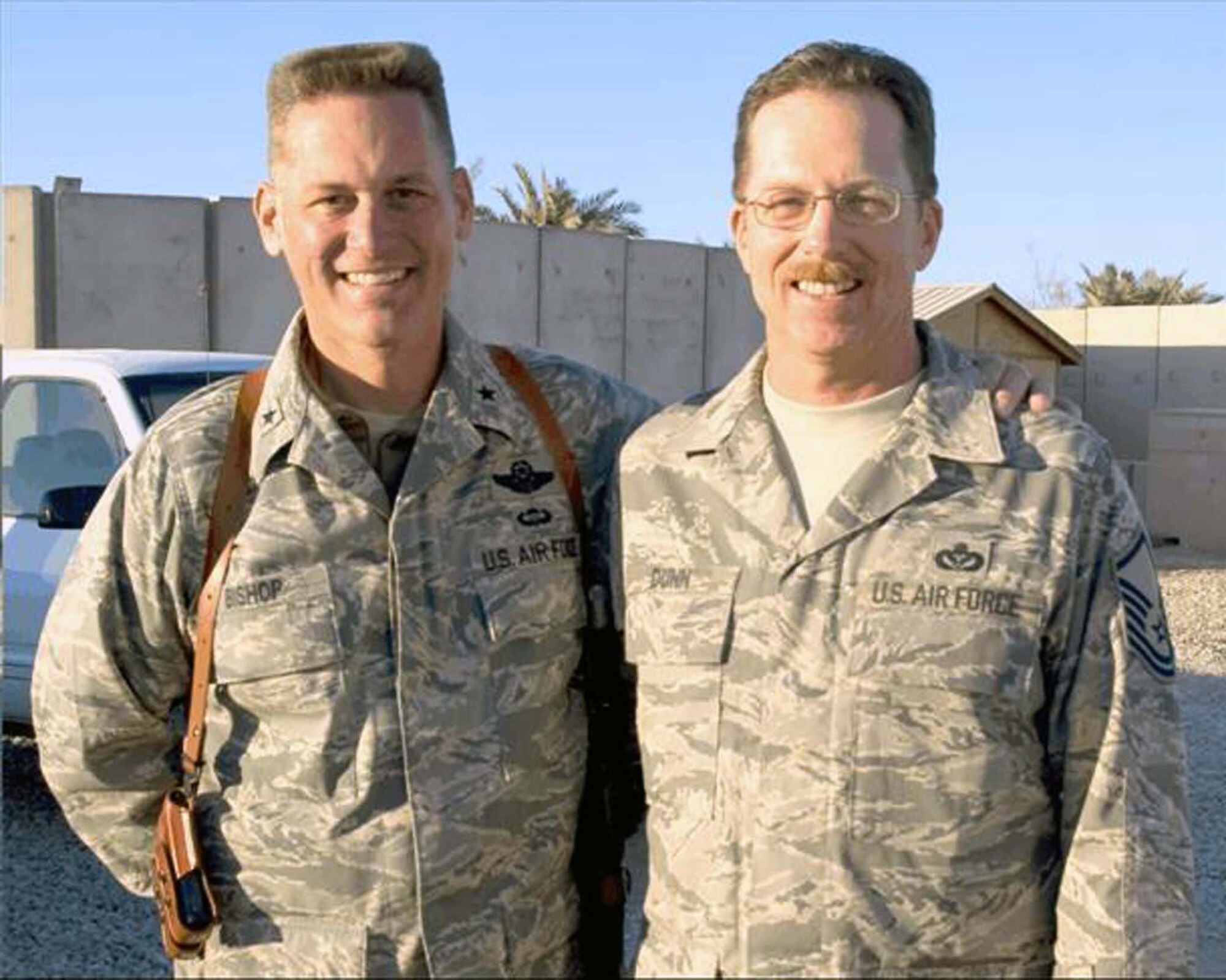 ALI AIR BASE, Iraq — Brig. Gen. Brian Bishop, 332nd Air Expeditionary Wing commander, and Master Sgt. Jeffrey Dunn, 407th Expeditionary Civil Engineer Squadron horizontal section chief, pose in another "sandbox," here in January. The two were childhood buddies at Mather Air Force Base, Calif., growing up in the 1960s. (U.S. Air Force photo/Senior Airman Christopher Griffin)