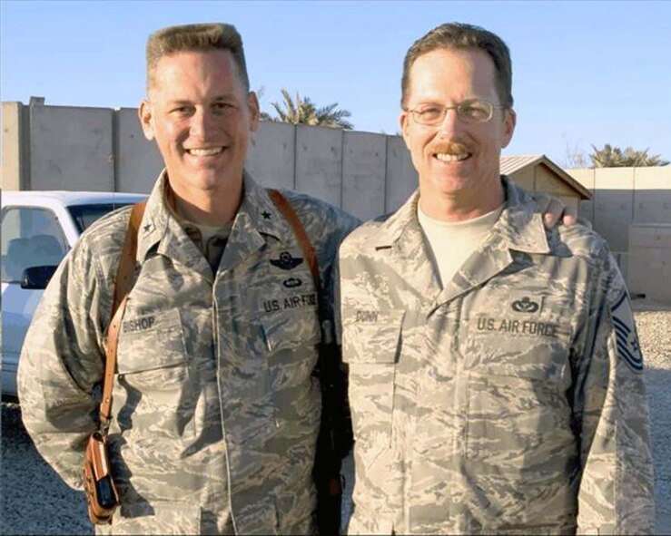 ALI AIR BASE, Iraq — Brig. Gen. Brian Bishop, 332nd Air Expeditionary Wing commander, and Master Sgt. Jeffrey Dunn, 407th Expeditionary Civil Engineer Squadron horizontal section chief, pose in another "sandbox," here in January. The two were childhood buddies at Mather Air Force Base, Calif., growing up in the 1960s. (U.S. Air Force photo/Senior Airman Christopher Griffin)