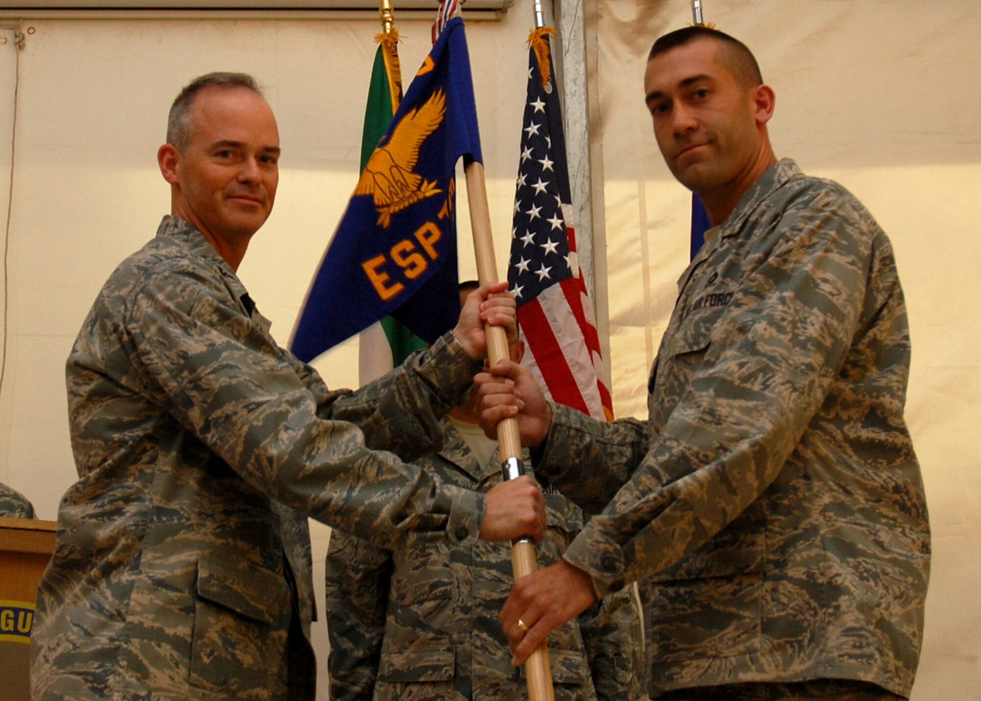 SOUTHWEST ASIA -- Lt. Col. James Downs assumes command of the 387th Expeditionary Support Squadron from Col. John Sullivan, 387th Air Expeditionary Group commander, at an air base in Southwest Asia, June 2. Colonel Downs is deployed from Los Angeles Air Force Base, Calif. (U.S. Air Force photo/ Capt. Angelic Dolan)