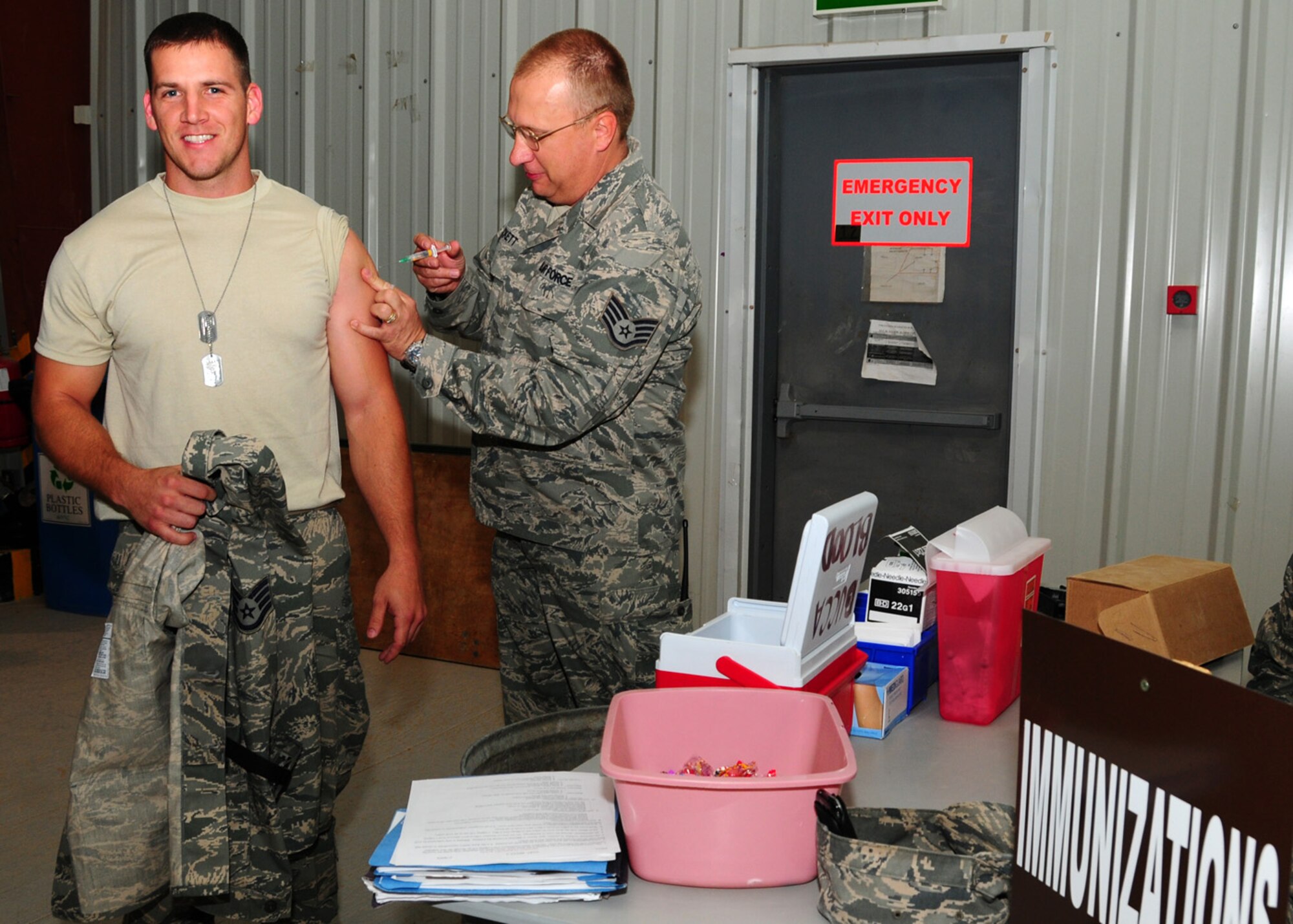 SOUTHWEST ASIA -- Staff Sgt. Brent Hart, 387th Expeditionary Civil Engineer Squadron, receives another dose in his series of anthrax shots at the in-processing briefing at an air base in Southwest Asia, June 1. The type and amount of shots Airmen receive on arrival to their deployed location depends on what was already given at home station and what's currently due. Sergeant Hart is deployed from Langley Air Force Base, Va., and is originally from Landrum, S.C. (U.S. Air Force photo/ Senior Airman Courtney Richardson) 