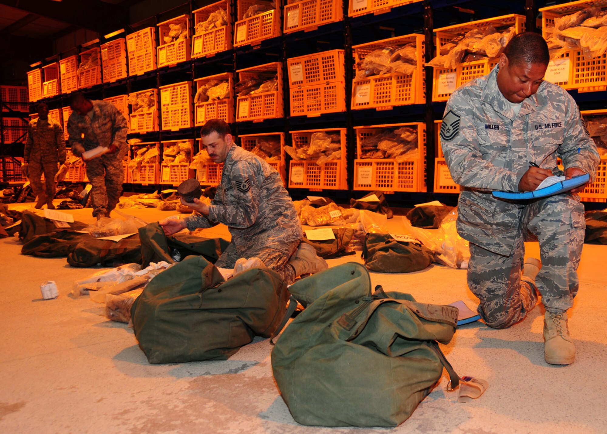 SOUTHWEST ASIA -- Master Sgt. Kelvin Miller, 386th Expeditionary Logistic Readiness Squadron, reviews the contents of a mobility bag to check for accountability of all items at the 386th Expeditionary Theater Distribution Center at an air base in Southwest Asia, May 29. This ETDC, one of three in theatre, issues out all the individual protective equipment necessary for Airmen going out into the Area of Responsibility. Sergeant Miller is originally from Oklahoma City, Okla. (U.S. Air Force photo/ Senior Airman Courtney Richardson)