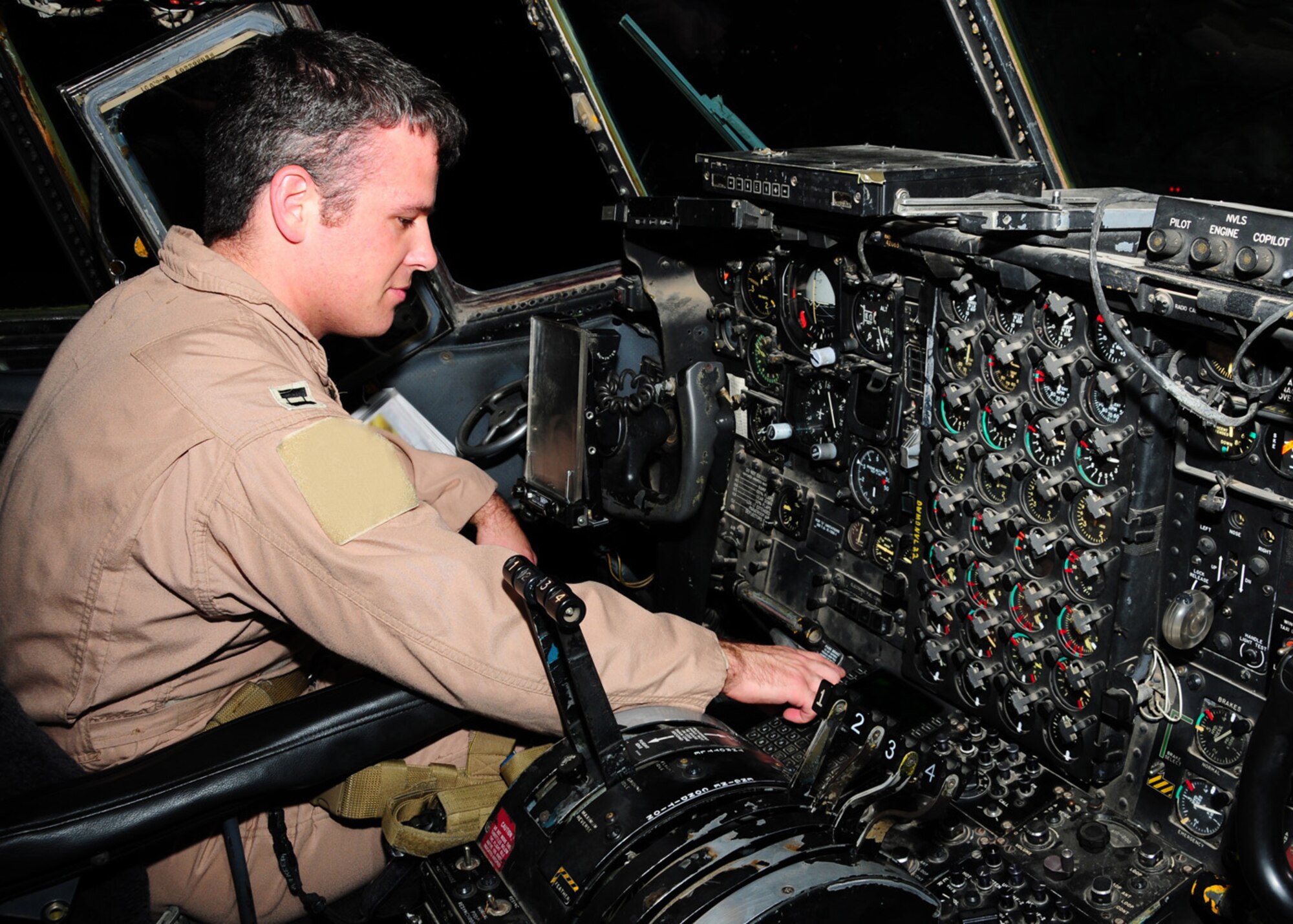 SOUTHWEST ASIA -- Capt. Andrew Gillis, 737th Expeditionary Airlift Squadron C-130 aircraft commander, test a navigation radio during his pre-flight check at an air base in Southwest Asia, May 28. The navigation radio is used during period of low flight visibility. Captain Gillis is deployed from Dyess Air Force Base, Texas, and is originally from San Jose, Calif. (U.S. Air Force photo illustration/ Senior Airman Courtney Richardson)