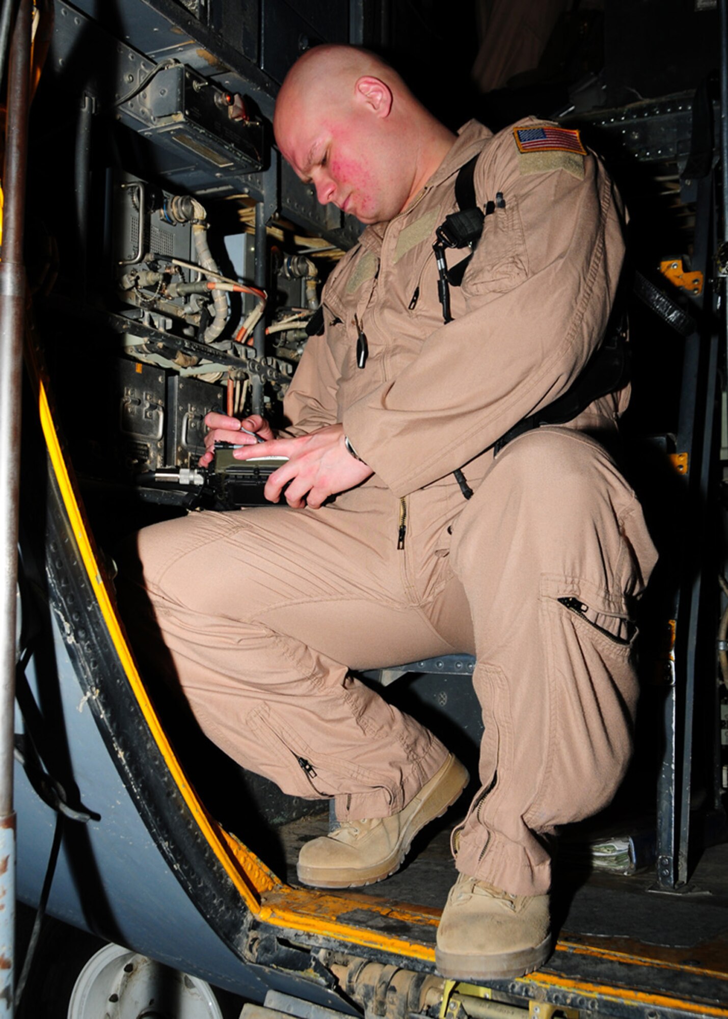 SOUTHWEST ASIA -- Capt. Geoff Guerra, 737th Expeditionary Airlift Squadron C-130 co-pilot, loads a secure radio during his pre-flight check at an air base in Southwest Asia, May 28. The secure radios are used as a backup communication method for air to ground contact. Captain Guerra is deployed from Dyess Air Force Base, Texas, and is originally from Bremerton, Wash. (U.S. Air Force photo illustration/ Senior Airman Courtney Richardson)