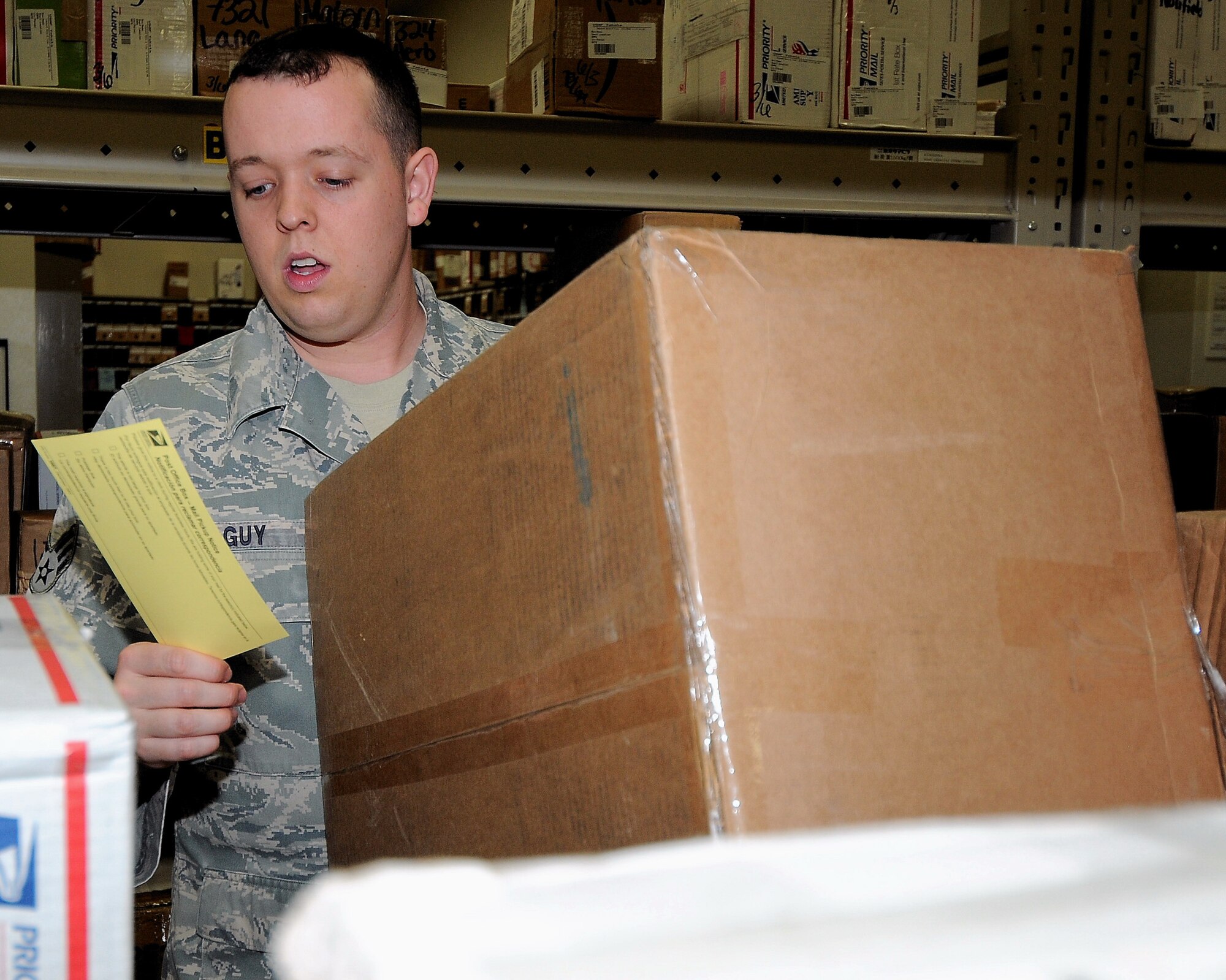 YOKOTA AIR BASE, Japan -- Senior Airman Adam Guy, 374th Communications Squadron, retrieves a customer's package at the post office June 4. The Yokota post office was awarded the 2008 Air Force Outstanding Large Postal Facility award. The unit was recognized for their environmentally friendly recycling program and security procedures. (U.S. Air Force photo/Airman 1st Class Michael Dillon)