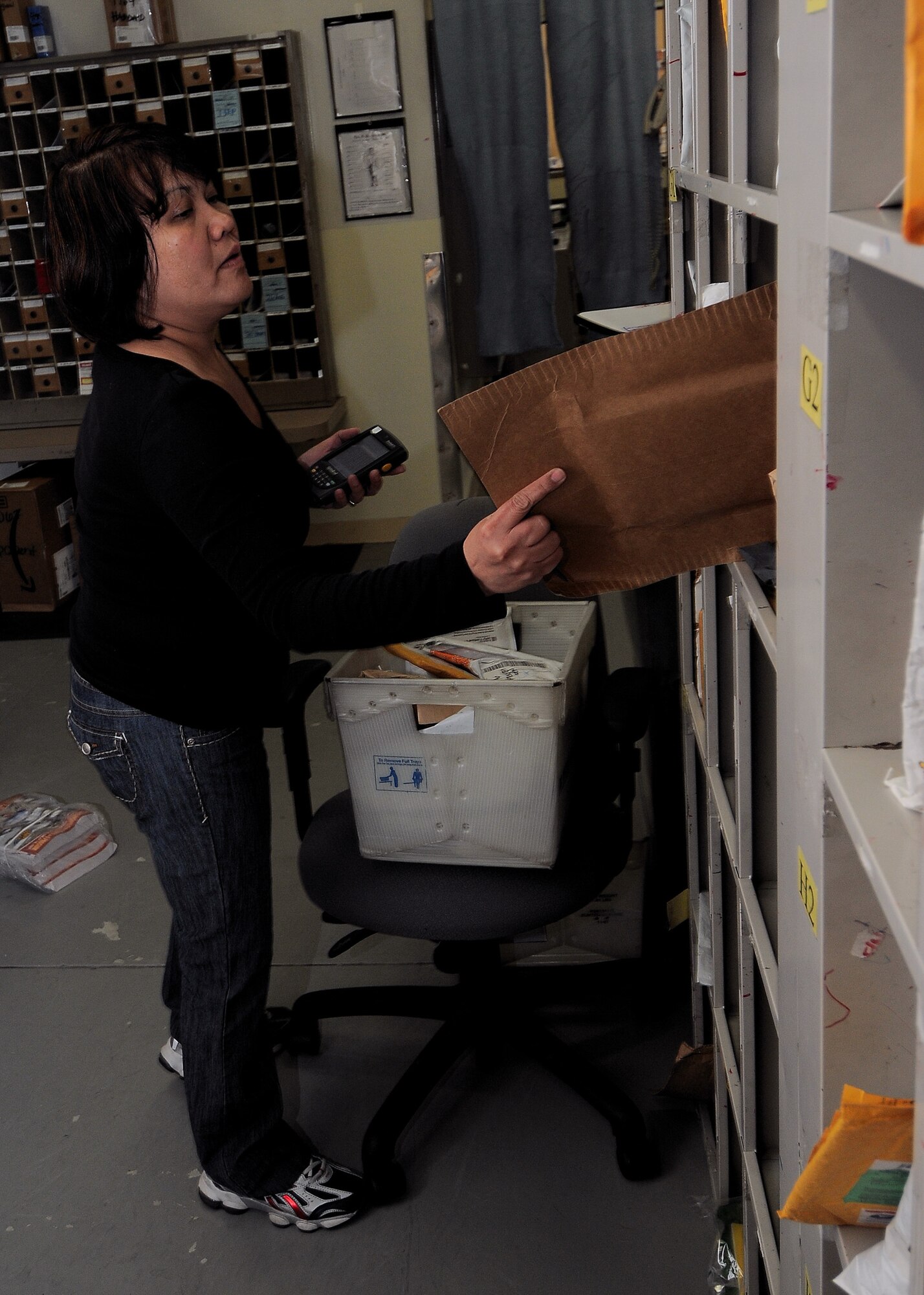 YOKOTA AIR BASE, Japan -- Chris Kirchner, 374th Communications Squadron, sorts through mail at the post office June 4. The Yokota post office was awarded the 2008 Air Force Outstanding Large Postal Facility award. The unit was recognized for their environmentally friendly recycling program and security procedures. (U.S. Air Force photo/Airman 1st Class Michael Dillon)