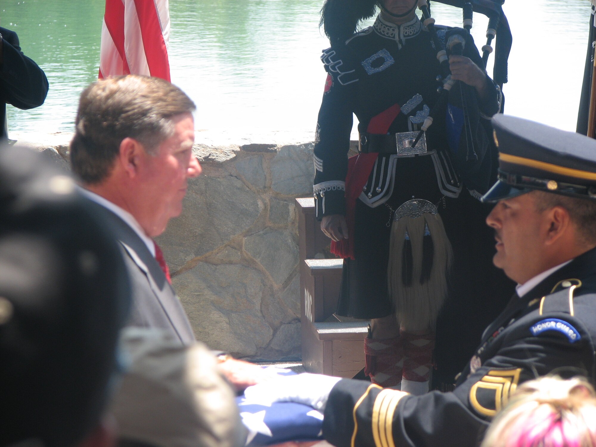 Congressman Ken Calvert is presented with a U.S. flag after the flag folding ceremony by the California Army National Guard. He was the keynote speaker. The flag symbolized all the men and women who were buried in the cemetery. The 1st Marine Division Band Brass Quintet played the National Anthem and Taps during the ceremony. The Master of Ceremonies was author Tom Ruck, who wrote “Sacred Ground: A Tribute to America’s Veterans.” The book highlights 47 national cemeteries across the United States. Army Maj. Gen. Mike Schweiger, who served as deputy commanding general for support of American forces during Operation Enduring Freedom and Operation Iraqi Freedom, represented the U.S. military members. (U.S. Air Force photos by Mrs. Walden)