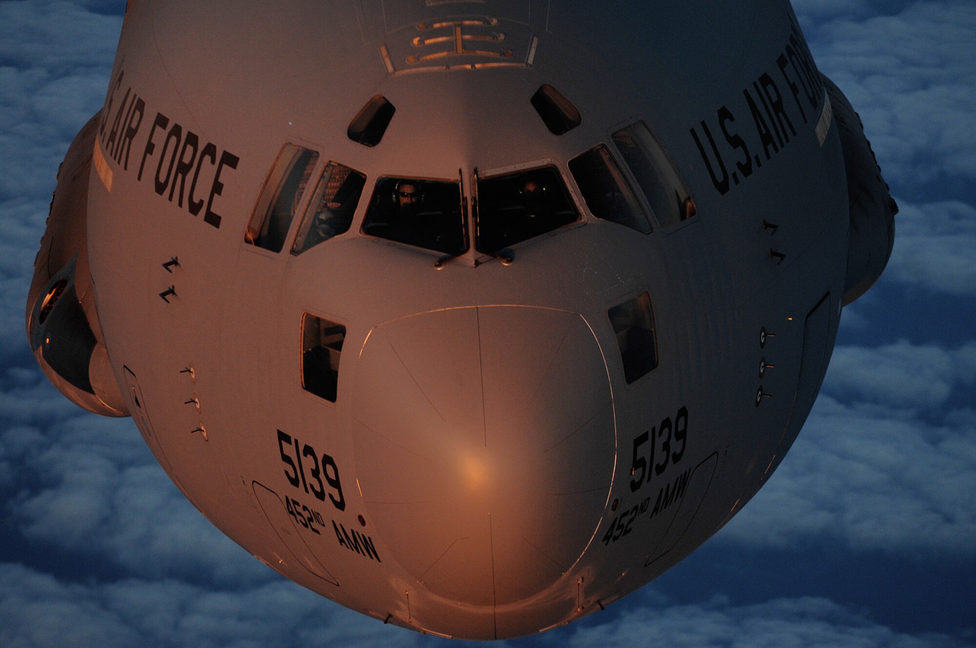 A C-17A Globemaster III, from the 729th Airlift Squadron, approaches a KC-135R Stratotanker, from the 336th Air Refueling Squadron May 20, above the clouds during an aerial refueling training mission. Both aircraft are based at March Air Reserve Base. (U.S. Air Force photo by Master Sgt. Rick Sforza)