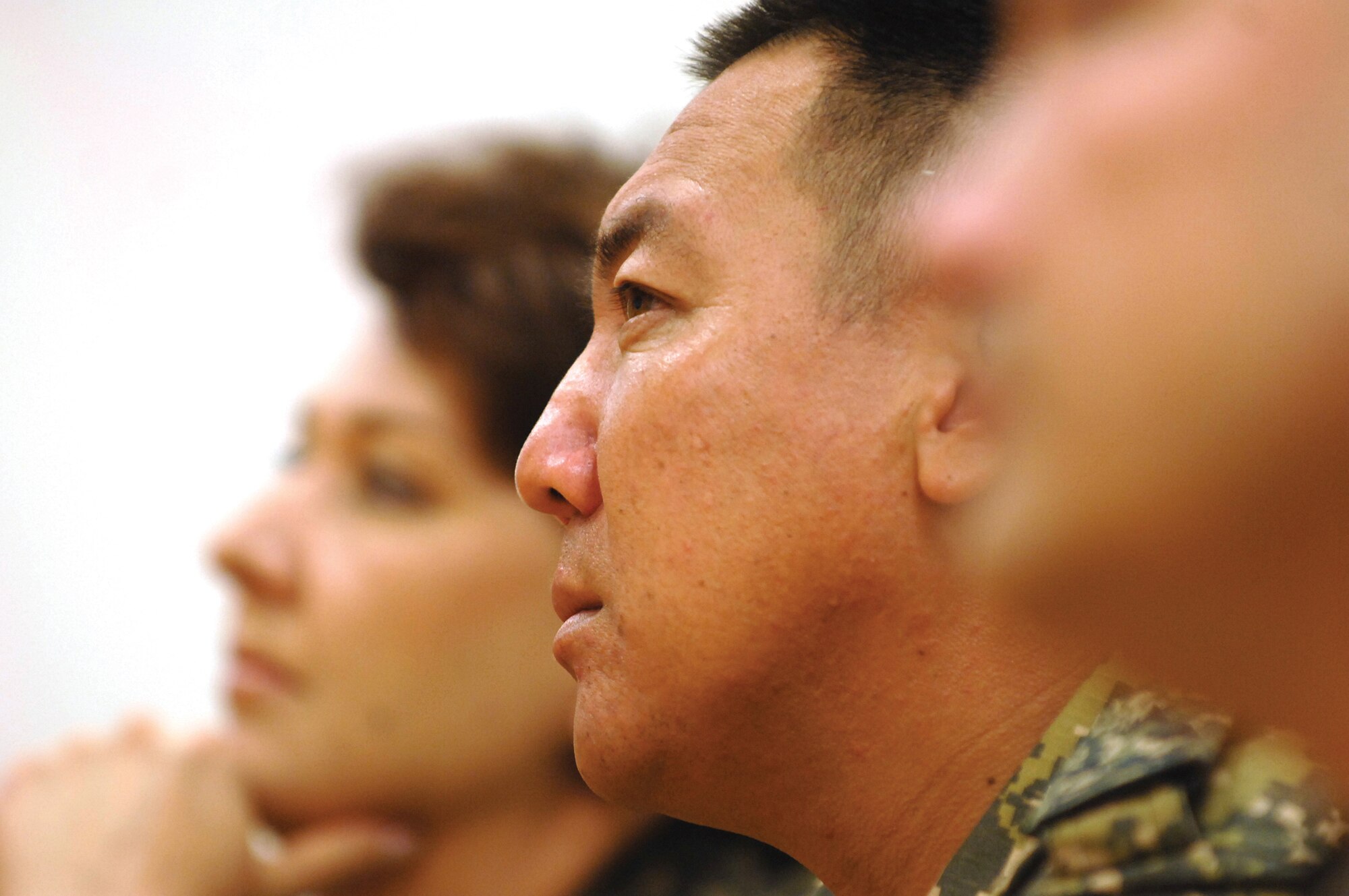 Justice Col. Timur Dandebayev, Kazakhstan Ministry of Defense, and other members of a visiting contingent from Kazakhstan, listen to a briefing given by Maj. Michael Borders, 56th Security Forces Squadron commander, at Luke. (U.S. Air Force photo/ Tech. Sgt. Jeffery Wolfe)