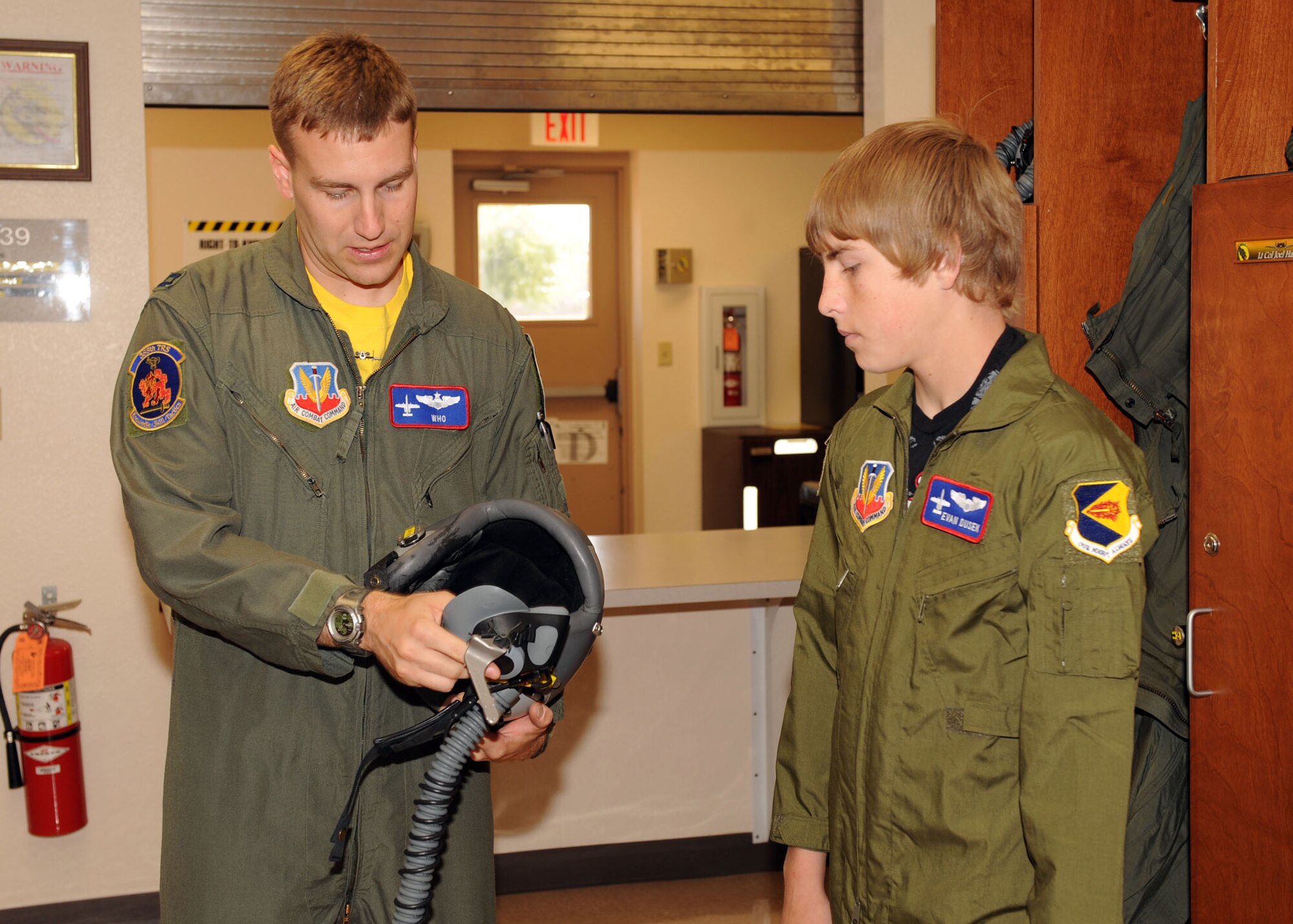 Capt. Karl Hagarty of the 355th Training Squadron, explains the pilot’s helmet to Pilot for a Day Evan Dusek during his visit here May 29. (U.S. Air Force photo/Airman 1st Class Brittany Dowdle)