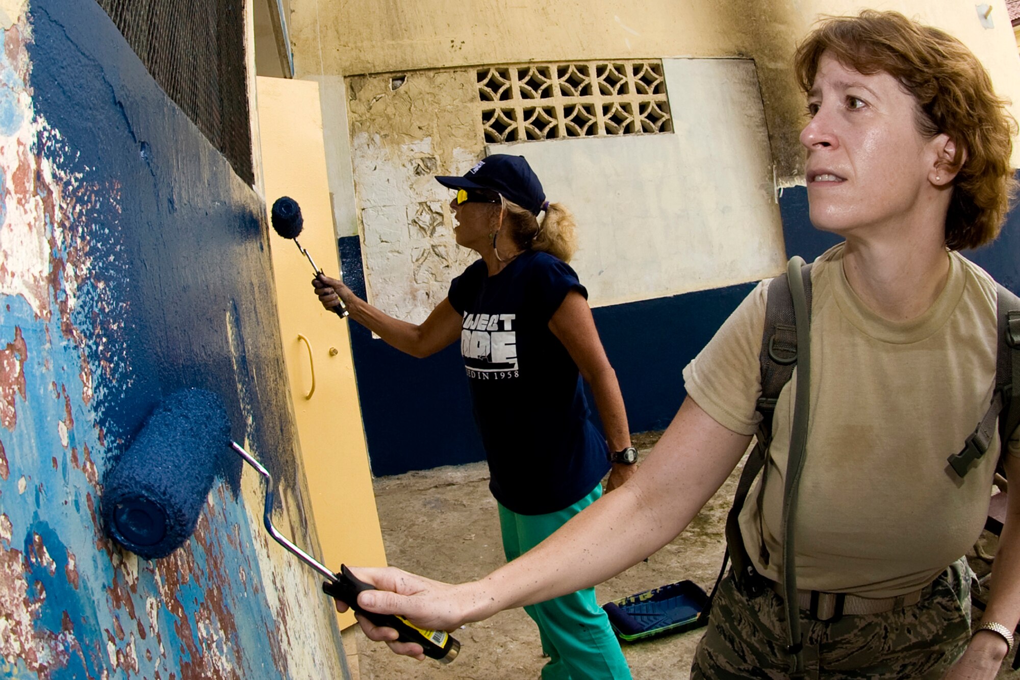 Maj. Penny Spaid (right) and others repaint the Juan Antion Henriquez Escuela May 30 in Colon, Panama. Major Spaid is a registered nurse assigned to the 10th Medical Operation Squadron at the U.S. Air Force Academy in Colorado Springs, Colo.  The USNS Comfort is currently supporting Continuing Promise 2009 on a four-month humanitarian mission to seven countries in Latin America and the Caribbean. (Defense Department photo/Benjamin Faske)