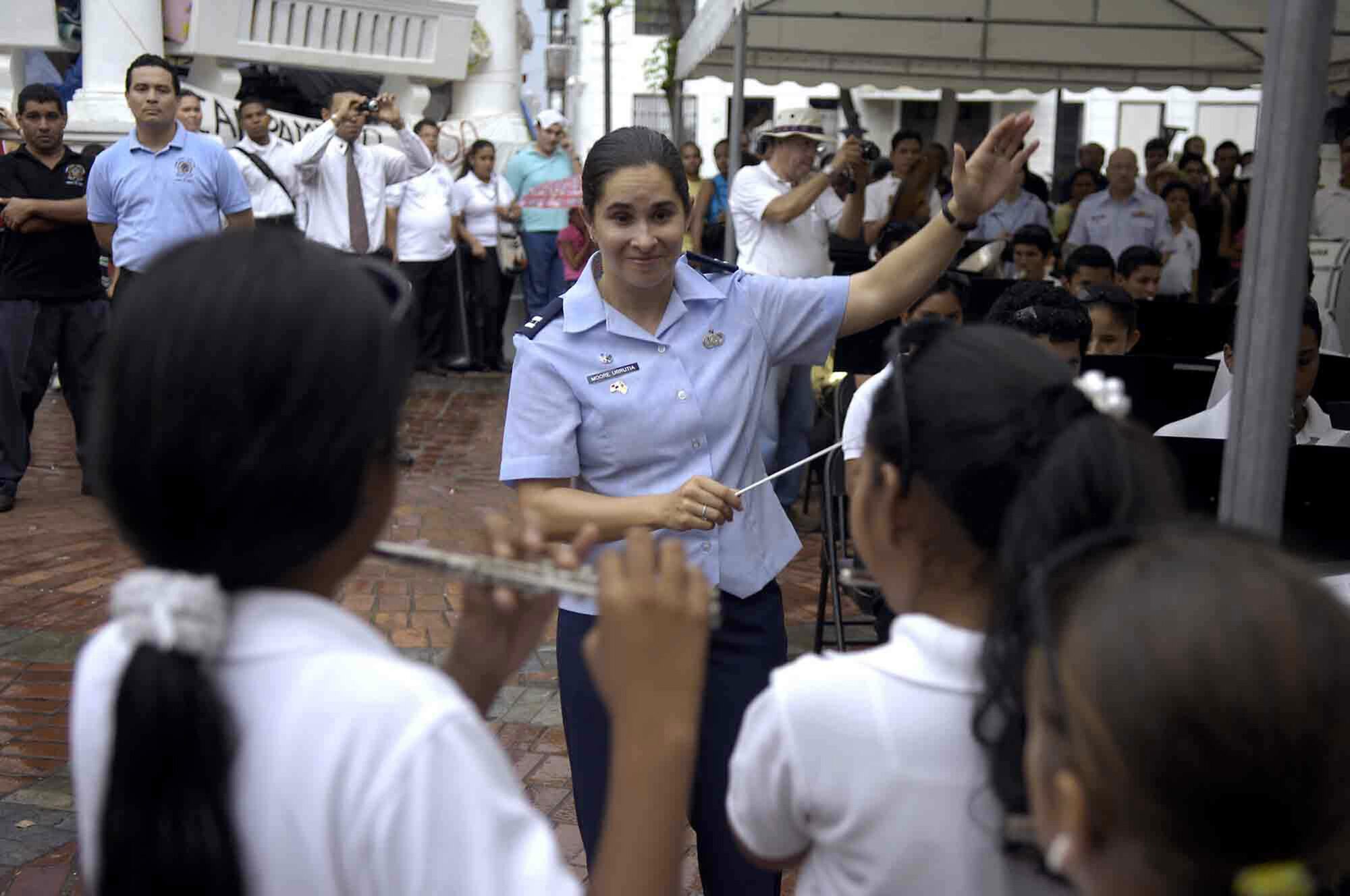 Capt. Christina Moore-Urrutia, the Air Force Band South conductor, directs a combined band of locals and military members during a special performance of "Stars and Stripes Forever" May 31 at Alfredo St. Malo Music Festival in Panama. The band is part of USNS Comfort's four-month humanitarian and civic assistance mission to Latin America and the Caribbean region called Continuing Promise 2009. (U.S. Air Force photo/Airman 1st Class Benjamin Stratton)