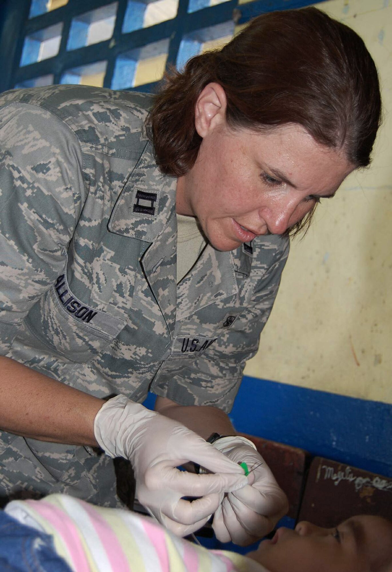 Capt. Terese Allison provides medical care to a Panamanian child in Colon, Panama, during Continuing Promise 2009. She is from the 59th Medical Group at Lackland Air Force Base, Texas. The USNS Comfort is currently supporting Continuing Promise 2009 with a four month humanitarian mission to seven countries in Latin America and the Caribbean (U.S. Air Force photo/Airman 1st Class Ashley Garcia)