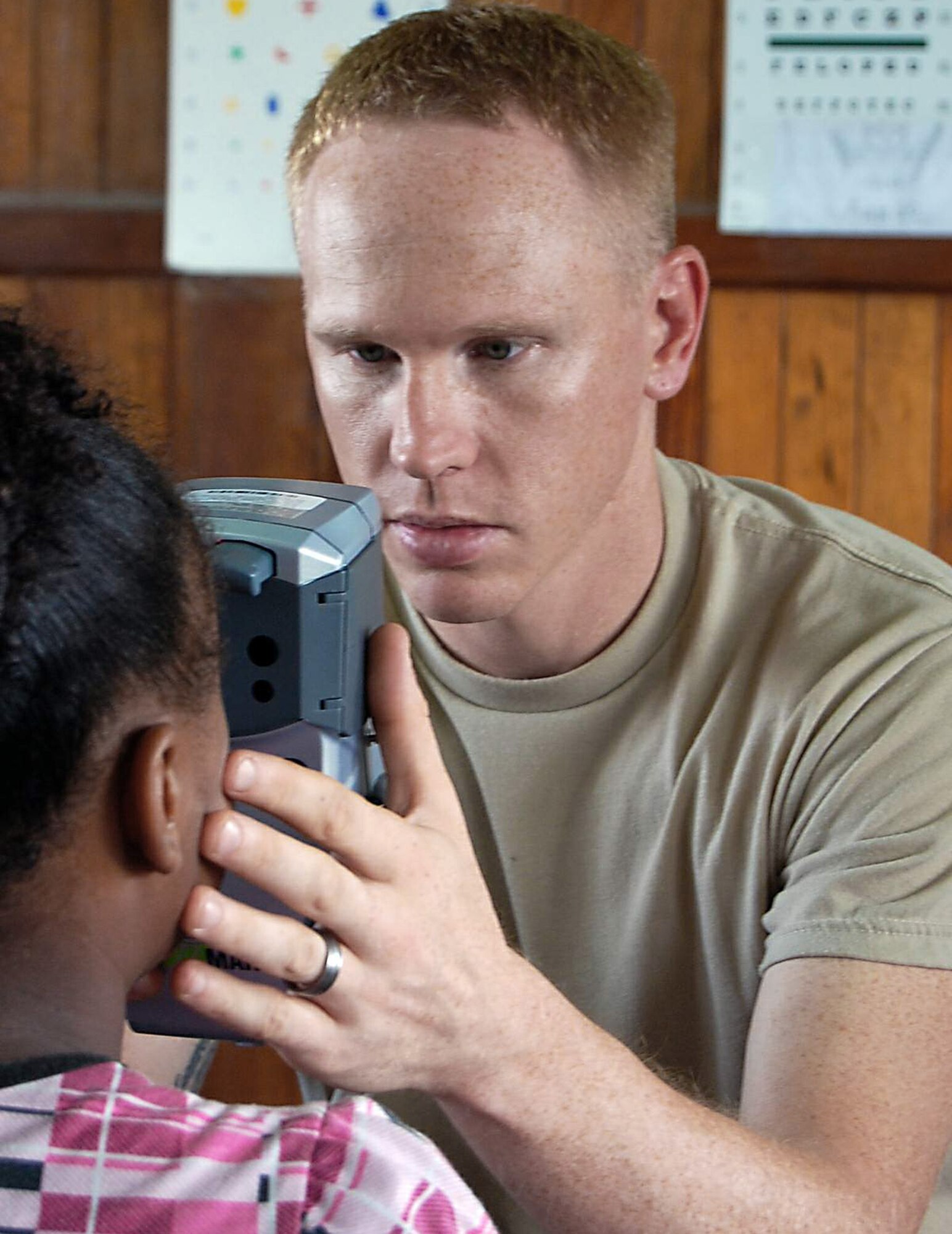 Tech. Sgt. Josh Karash performs an eye exam on a Panamanian child in Colon, Panama, during Continuing Promise 2009. He is from the 56th Aerospace Medicine Squadron at Luke Air Force Base, Ariz. The USNS Comfort is currently supporting Continuing Promise 2009 with a four month humanitarian mission to seven countries in Latin America and the Caribbean  (U.S. Air Force photo/Airman 1st Class Ashley Garcia)