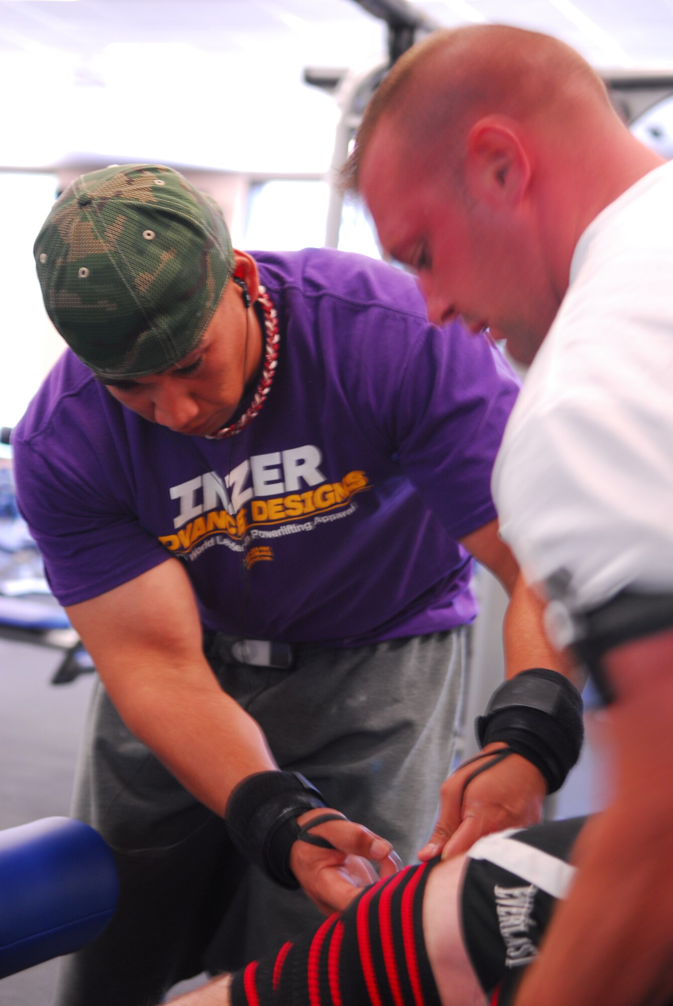 VANDENBERG AIR FORCE BASE, Calif. – Helping his fellow Airman tighten an athletic weightlifting wrap, Staff Sgt. Eduardo Rojas, a 30th Security Forces Squadron military working dog trainer, preps Staff Sgt. Sean Yargus, a 30th SFS patrolman, before a set of squats at the Fitness Center here June 4. Sergeants Rojas and Yargus were part of a three-member team from the 30th SFS that competed and scored high in the United States Powerlifting Federation Military Nationals Championship at Venice Beach, Calif., May 23. (U.S. Air Force photo/Airman 1st Class Steve Bauer)