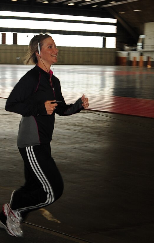 Tech. Sgt. Ann Mitchell, 28th Force Support Squadron NCO in charge of readiness, runs at the PRIDE Hangar here, June 3.  Sergeant Mitchell runs to prepare herself as part of a seven-person-marathon team led by Maj. Launa Bellucci, 28 FSS commander. (U.S. Air Force photo/Senior Airman Anthony Sanchelli)