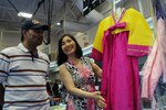 Jon Sun Tomlin displays traditional Korean dresses to passers-by at the festival. (U.S. Air Force photo by Don Lindsey)