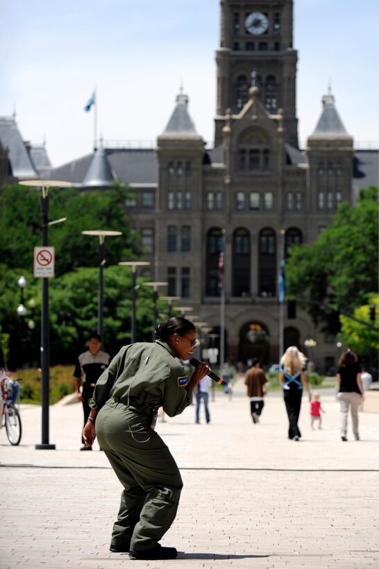 Master Sgt. Regina Coonrod sings in the Salt Lake City library square, with the Salt Lake City County Building in the background, June 3. MSgt. Coonrod is a vocalist with the U.S. Air Force Band, Max Impact, who will be performing tonight at Eagle Mountain City at 6:30 pm and Friday at the Bountiful City Park at 7 p.m. (U.S. Air Force photo by James Arrowood)
