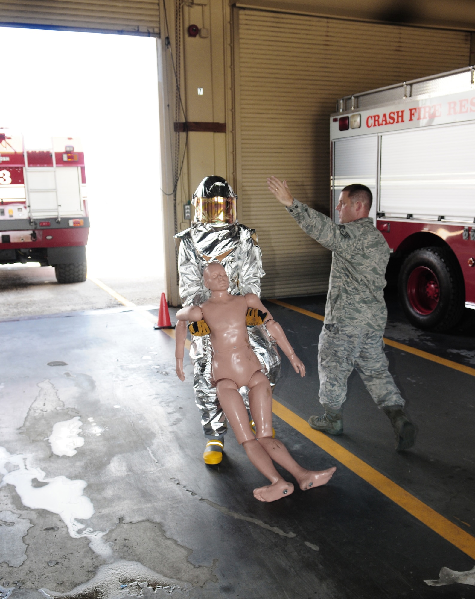 A U.S. Air Force Academy cadet does a body drag as one section of nine in a firefighter physical training competition May 19 at Andersen Air Force Base, Guam. The fire house offered a unique perspective for the third-year cadets. (US Air Force photo/Tech. Sgt. Michael Boquette)