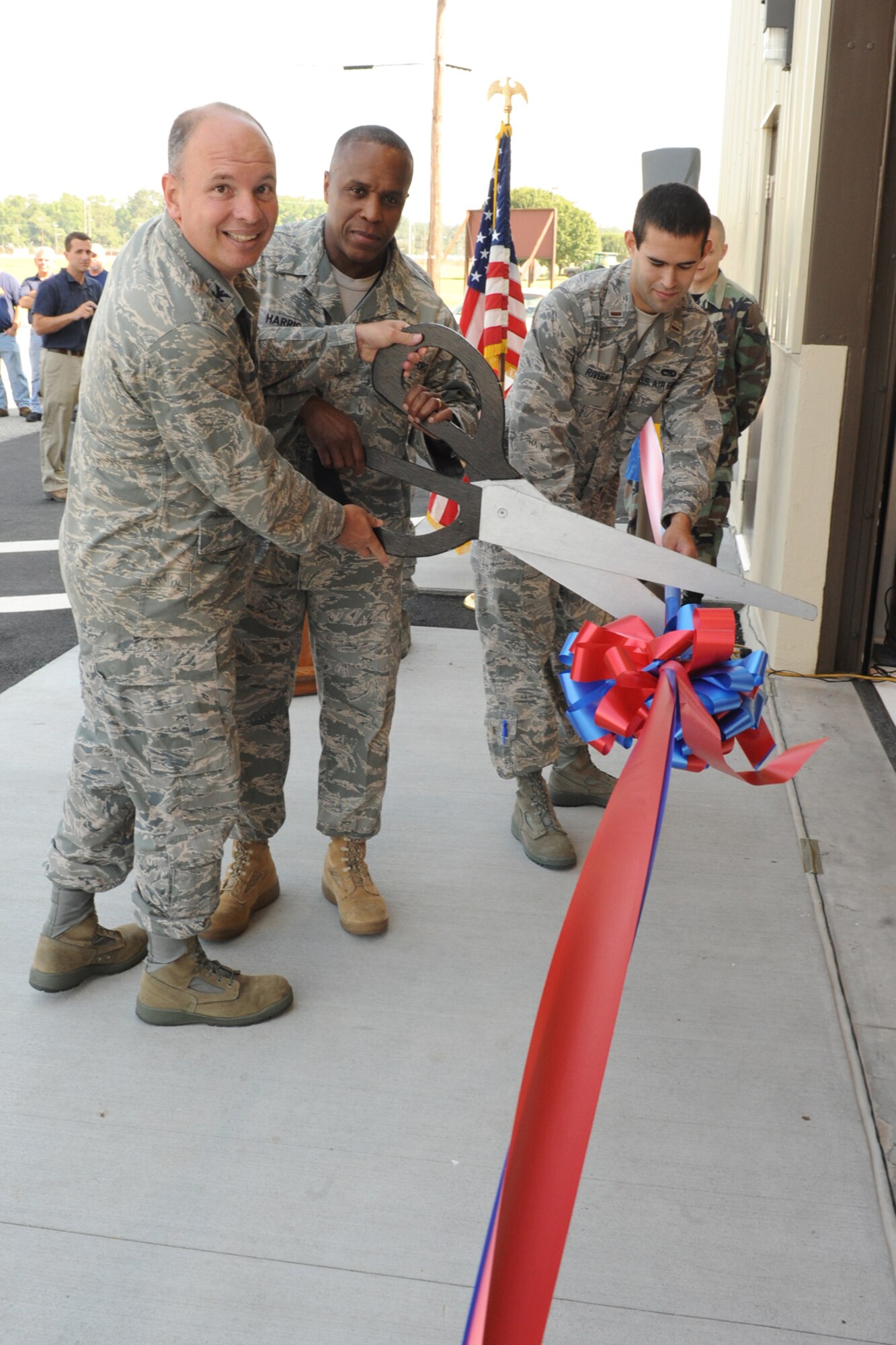 Colonel Joseph Diana (left), Chief Master Sgt. Owen Harris (center), and 2nd Lt. Michael Rivera (right), all from  the 4th Maintence Group, cut a ceremonial ribbon to open the new propulsion maintenance hangar on Seymour Johnson Air Force Base, N.C., June 2, 2009. The new hangar provides a larger work area with improved climate control for Airmen. (U.S. Air Force photo by Airman 1st Class Whitney S. Lambert)