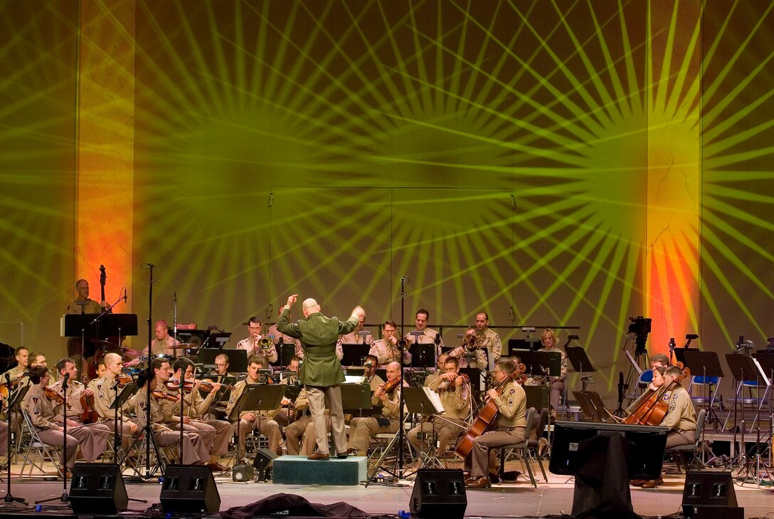Feb. 2007:  Donned in WWII era “pinks and greens” uniform, Colonel Layendecker conducts the Air Force Strolling Strings and Airmen of Note during a Guest Artist Series performance at DAR Constitution Hall. (Photo provided by David Litvin)
