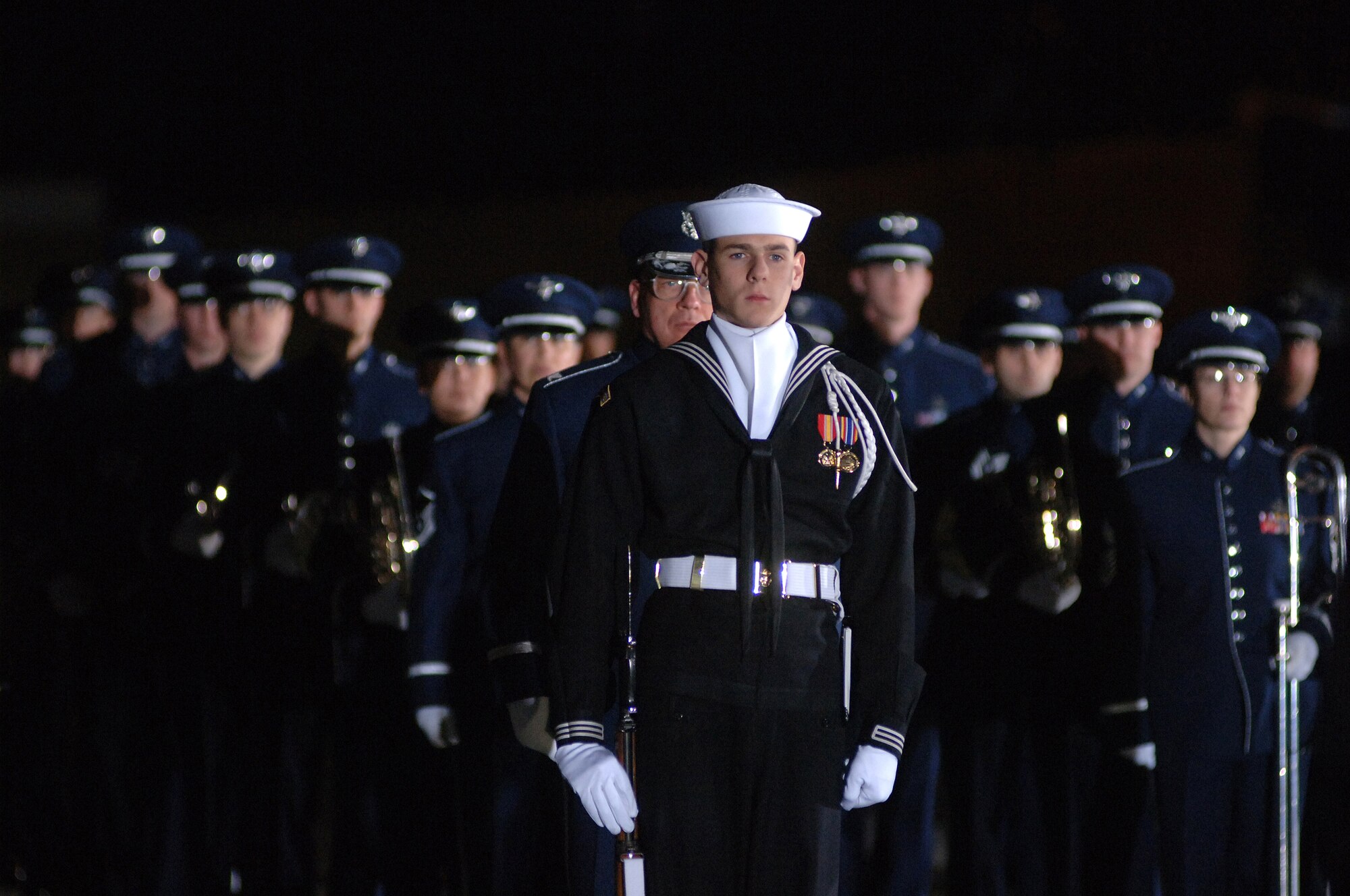 Dec. 2006:  The Ceremonial Honor Guard and United States Air Force Band stand at the ready as the casket of Gerald R. Ford, 38th President of the United States, arrives at Andrews Air Force Base. (Photo by Technical Sgt. Christopher Matthews) 