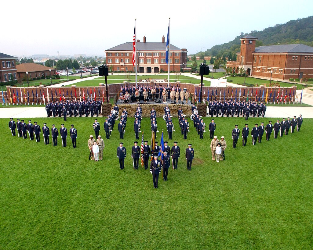 July 2004:  Colonel Layendecker (first row, 1st from left) poses with 11th Wing leadership, members of the U.S. Air Force Ceremonial Brass, Max Impact (on stage), and the U.S. Air Force Honor Guard for the Bolling AFB Tattoo Ceremony. (USAF photo)