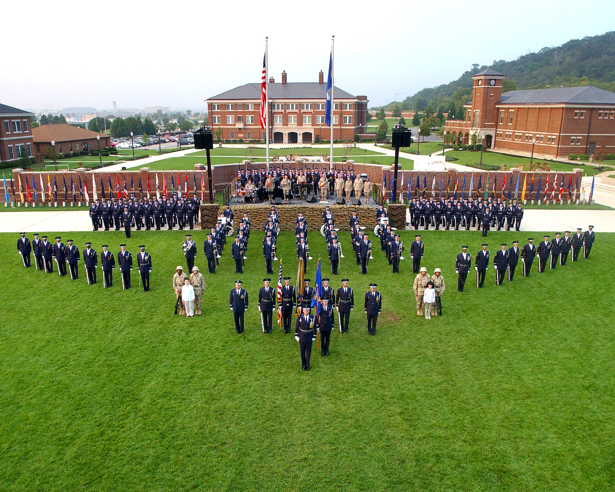 July 2004:  Colonel Layendecker (first row, 1st from left) poses with 11th Wing leadership, members of the U.S. Air Force Ceremonial Brass, Max Impact (on stage), and the U.S. Air Force Honor Guard for the Bolling AFB Tattoo Ceremony. (USAF photo)