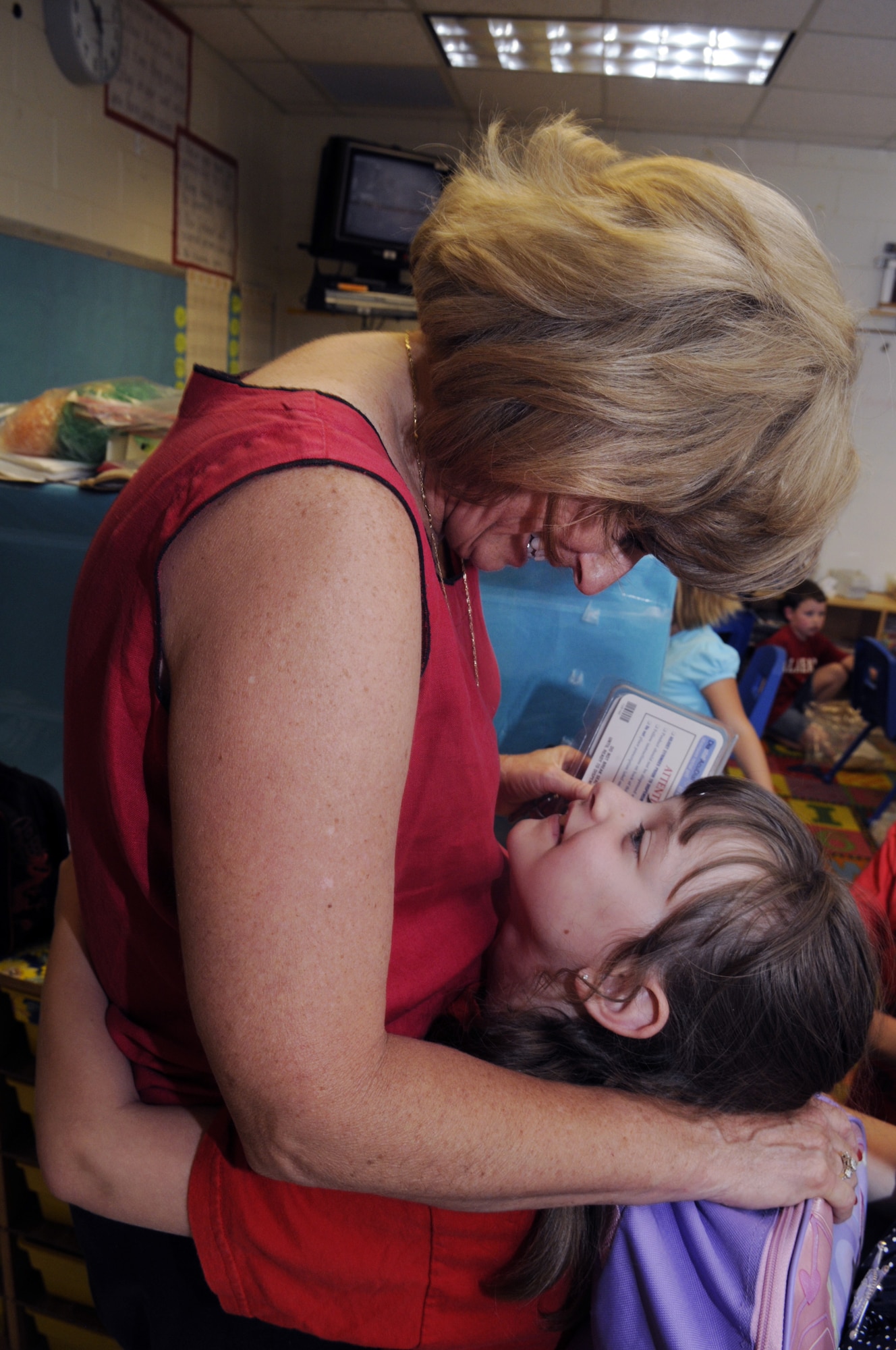Lea Floyd, Robins Elementary School nurse gets a hug from Laura Wilson at the end of school on the last day. Laura will be a 2nd grade student at Linwood Elementary next school year. U. S. Air Force photo by Sue Sapp
