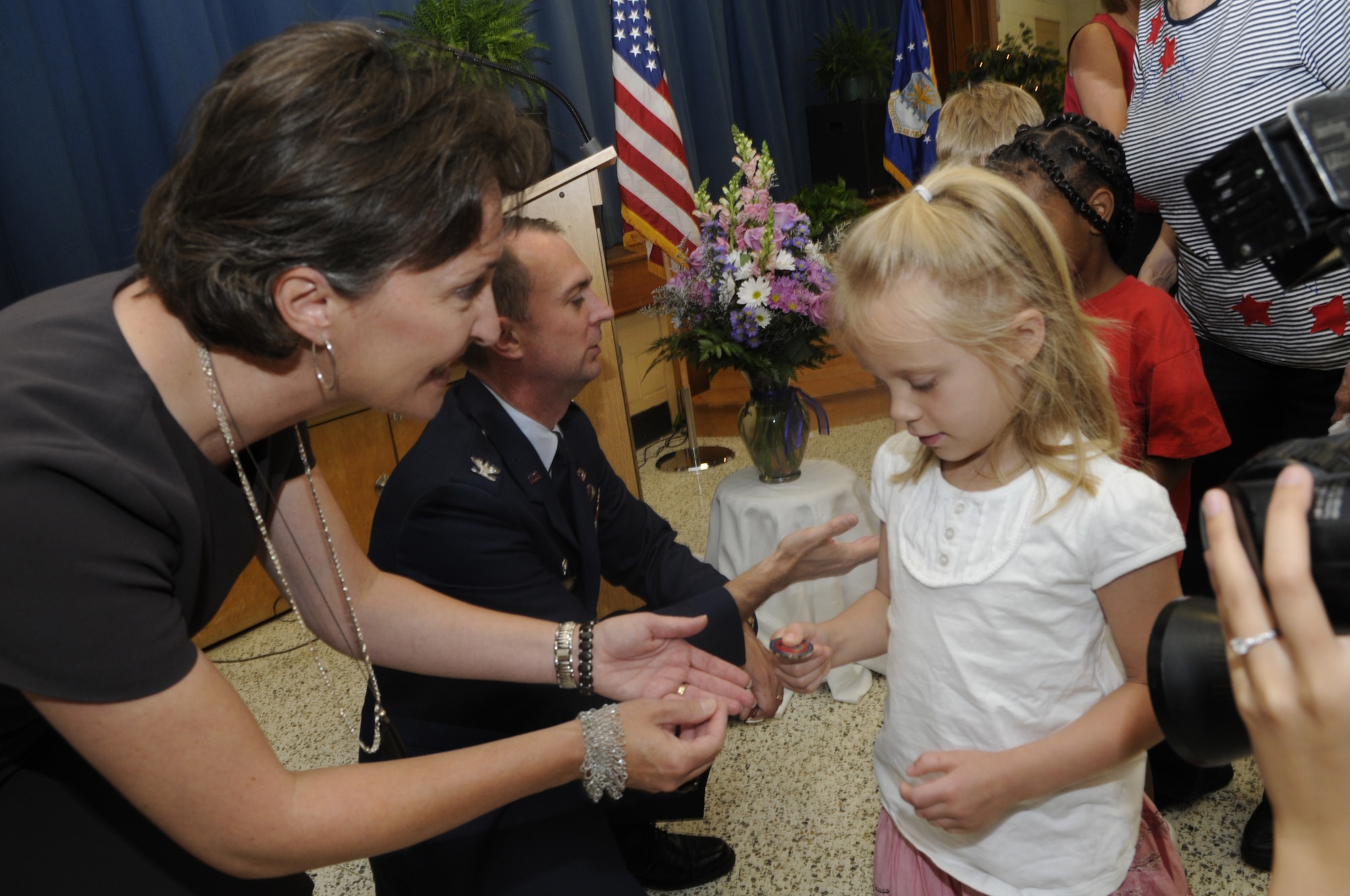 Each Robins Elementary student received a coin given out by Col. Warren Berry, 78th Air Base Wing commander and his wife Marie. U. S. Air Force photo by Sue Sapp