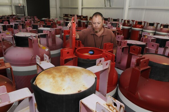 Todd Hurlburt checks on the storage containers of halon that will be reused. U. S. Air Force photo by Sue Sapp