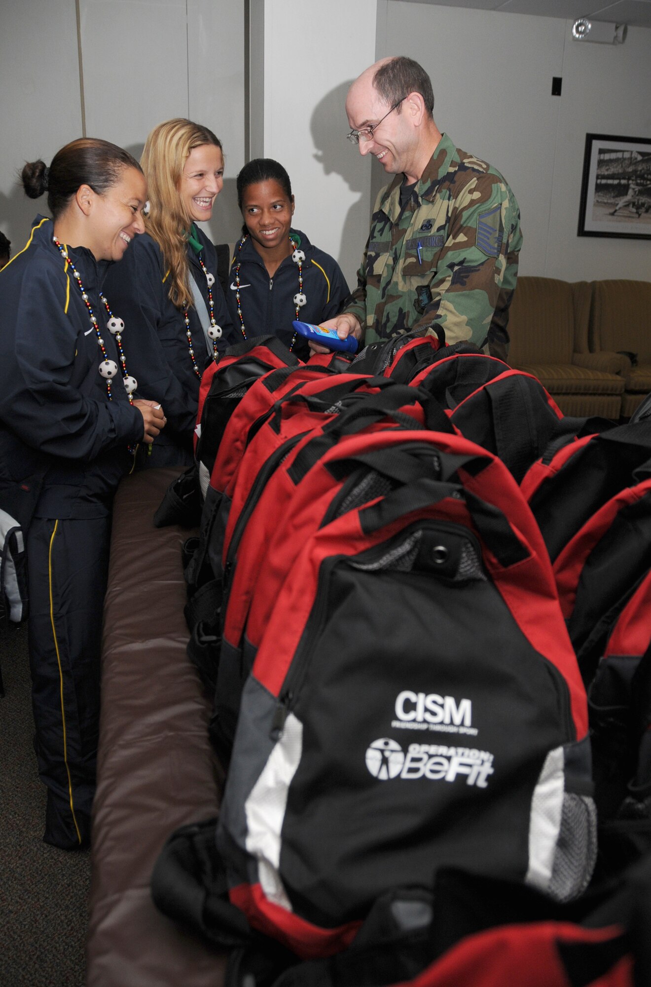 From left, Brazilian soccer players Roberte Lima, Renata Costa and Daniele
Silva meet with Master Sgt. Mark Guice, a volunteer from the 81st Training
Support Squadron, to receive sports bags containing sun screen, water bottle
and other items needed to beat Mississippi's heat during the Conseil
International du Sport Militaire 5th Women's World Military Football
(Soccer) Championship hosted by Keesler.  Games begin June 6, with the
championship game at 2 p.m. June 13 at the Biloxi High School stadium.  In
addition to the U.S. and Brazilian teams, other competitors are from The
Netherlands, France, Canada, South Korea and Germany.  (U.S. Air Force photo by Kemberly Groue)

