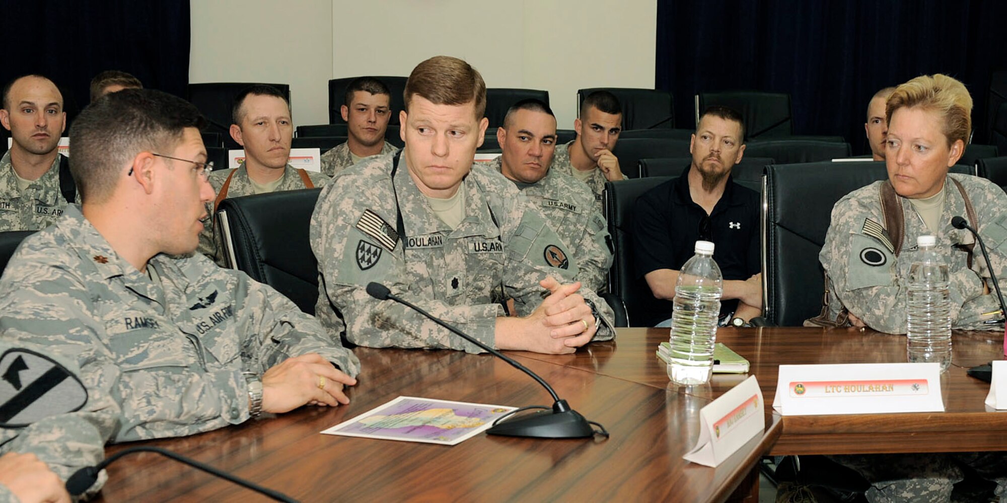 Maj. Richard Ramsey (left to right) discusses with Army Lt. Col. James Houlahan and Army Brig. Gen. Heidi V. Brown about an Air Force program already in use in Afghanistan that could work here at the Multinational Corps-Iraq Joint Operations Center May 31 at Camp Victory, Iraq. Key players from the Army, Air Force and civilians from all over Iraq and the Combined Air Operations Center discussed the complexities of managing the joint air picture and how to improve joint tactics, techniques and procedures. Major Ramsey is a joint interface control officer at the Combined Air Operations Center deployed from Hill Air Force Base, Utah. He is a native of Joliet, Ill. Colonel Houlahan is the Multinational Corps-Iraq air missile defense cell chief and General Brown is the MNC-I deputy commander. They are deployed from Fort Lewis, Wash. (U.S. Air Force photo/Senior Airman Jacqueline Romero)
