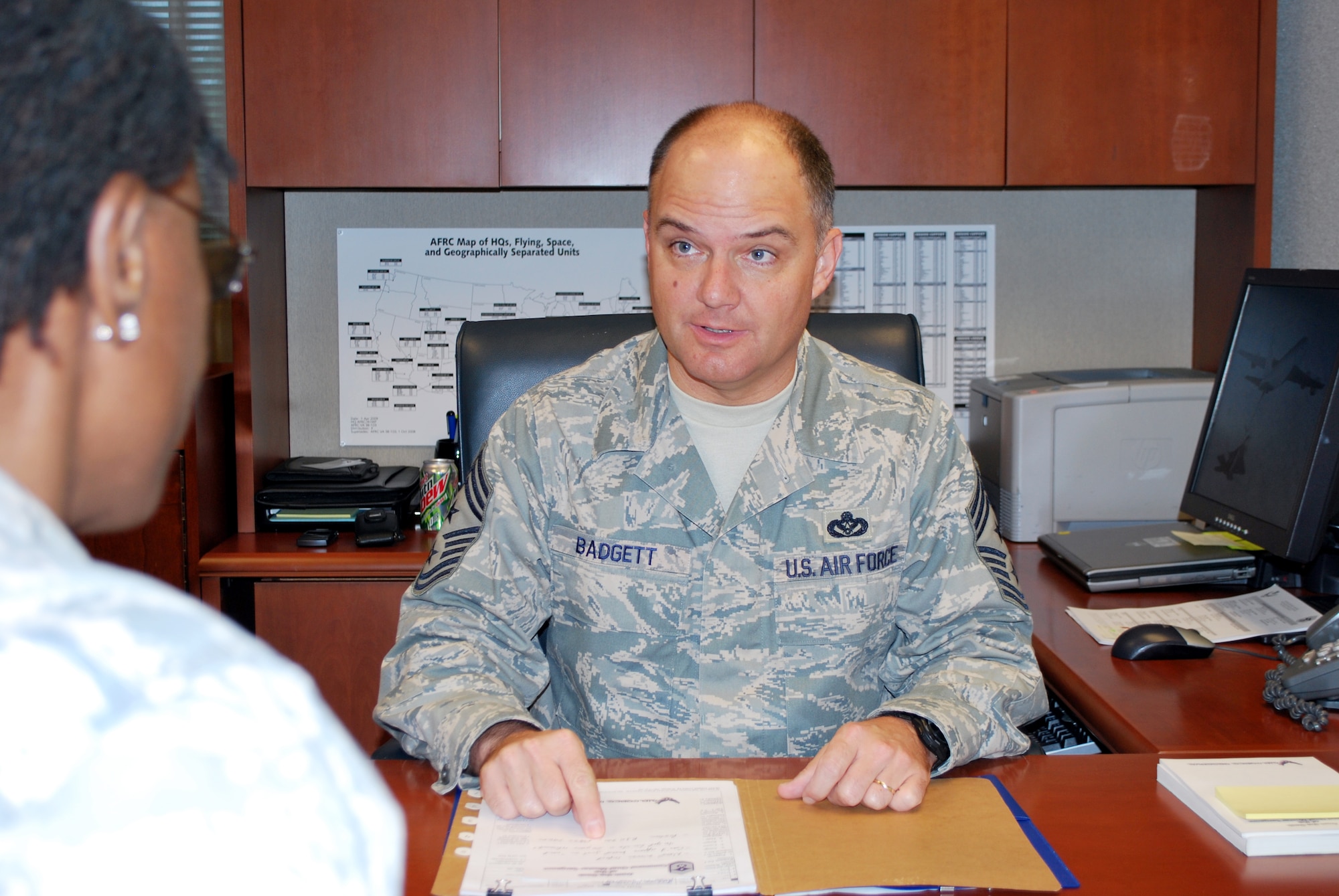 Chief Master Sgt. Dwight D. Badgett, command chief master sergeant for Air Force Reserve Command, speaks with Senior Master Sgt. Cathy Williams, special assistant to the command chief, about items of interest to Airmen at the command headquarters at Robins Air Force Base Ga. Chief Badgett advises the commander on all matters concerning the health, morale, welfare and effective utilization of enlisted Airmen at 66-plus locations. (U.S. Air Force photo/Staff Sgt. Celena Wilson)