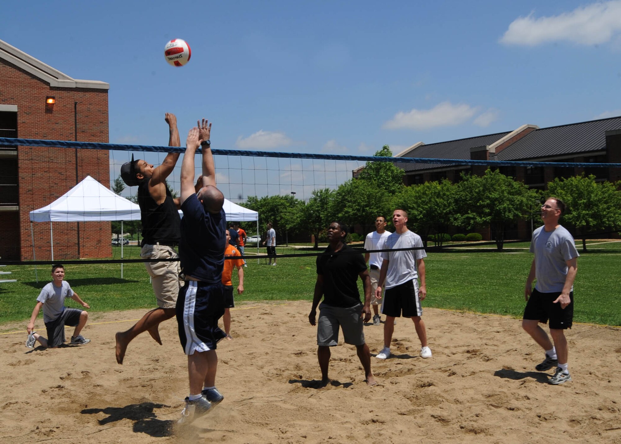 SCOTT AIR FORCE BASE, Ill. -- Airmen participate in a game of volleyball at the Dorm Olympics held Friday at Scott.  Airmen competed in a variety of events such as volleyball, basketball, a golf chip-shot challenge, dunk tank and a musical video game challenge. Dorm residents ate free food and drinks provided by the First Sergeants of Scott.

 (U.S. Air Force photo/Airman 1st Class Wesley Farnsworth)
