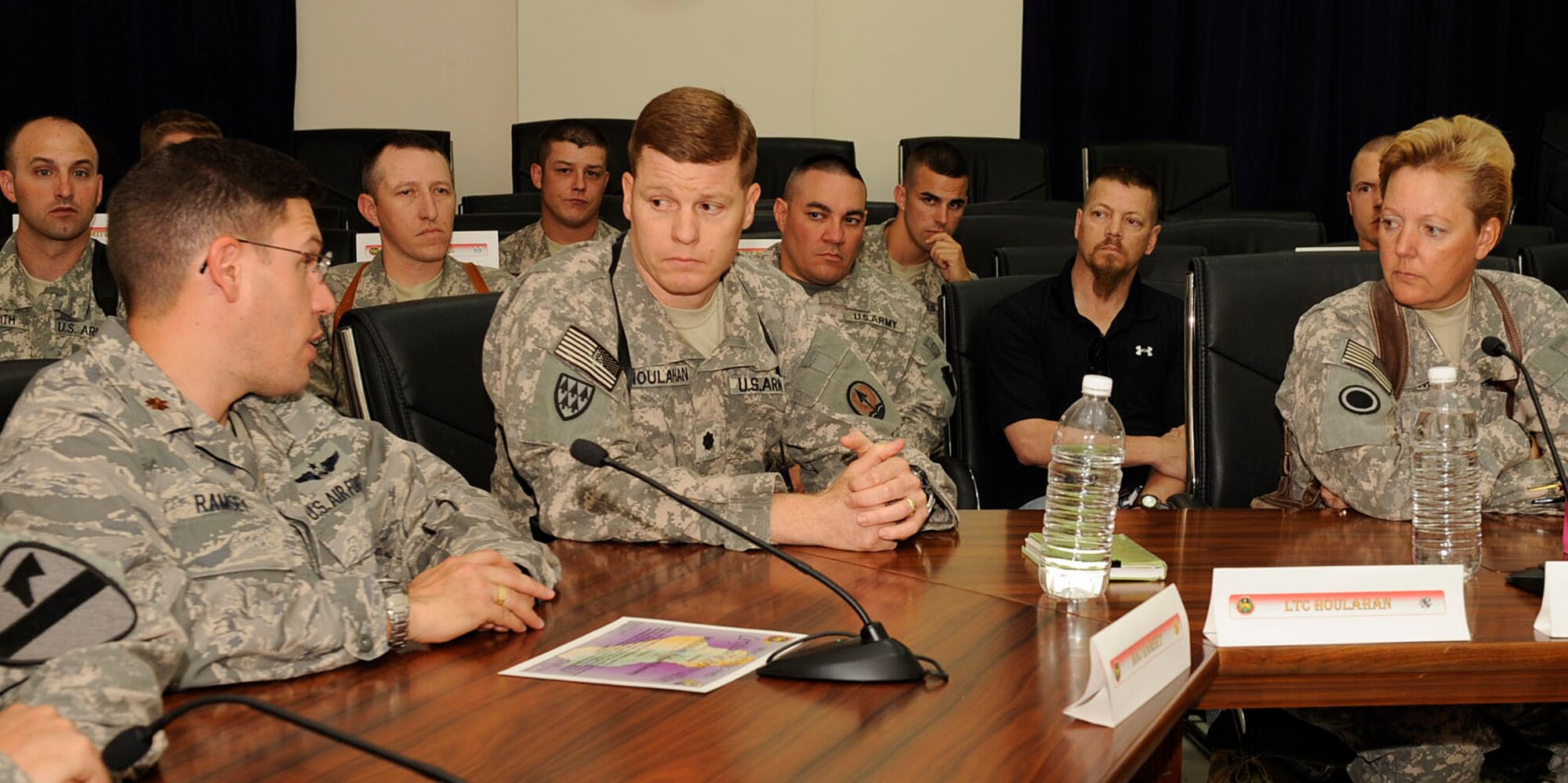 (Left to Right) Maj. Richard Ramsey, joint interface control officer at the Combined Air Operations Center, discusses with Army LTC James Houlahan, Multi-National Corps- Iraq Air Missile Defense cell chief, and Brig. Gen. Heidi V. Brown, MNC-I deputy commander, [about an Air Force program, already in use in Afghanistan, which could work here at the Multi-National Corps Iraq Joint Operations Center. Key players from the Army, Air Force and civilians from all over Iraq and the Combined Air Operations Center, discuss the complexities of managing the joint air picture and how to improve joint tactics, techniques, and procedures. Major Ramsey is deployed from Hill Air Force Base, Utah and is a native of Joliet, Ill.  Colonel Houlahan and General Brown are deployed from Fort Lewis, Wash., and are natives of El Paso, Texas.  (U.S. Air Force Photo by Senior Airman Jacqueline Romero)