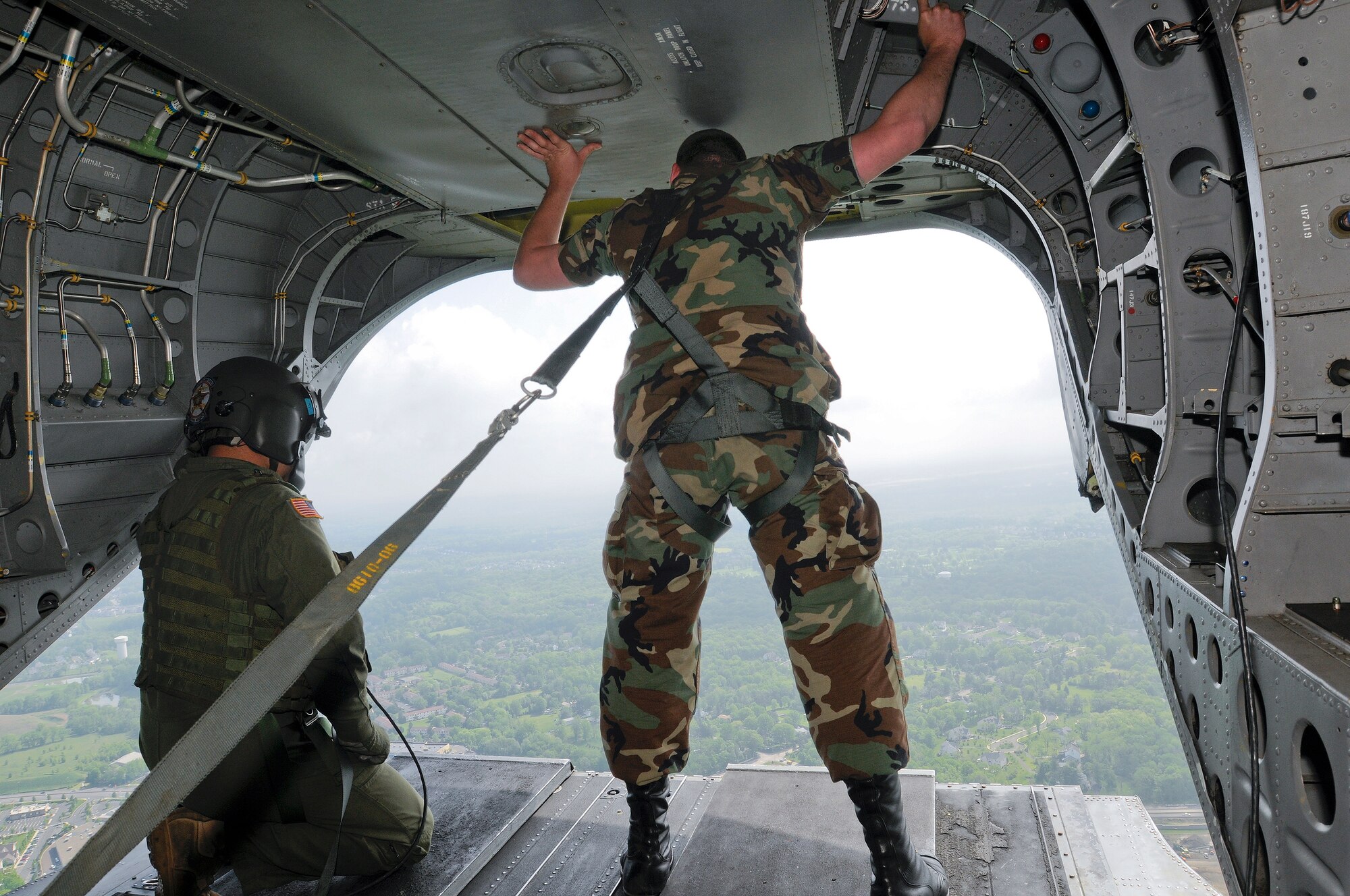 Staff Sgt. Christopher K. Spencer, 270th Engineering Installation Sq. looks out the back of a CH-47 Chinook helicopter on his way to take part in an A-10 live fire and combat search and rescue (CSAR) demonstration at Bollen Air-to-Ground Weapons Range, Fort Indiantown Gap, Pa. May 15.