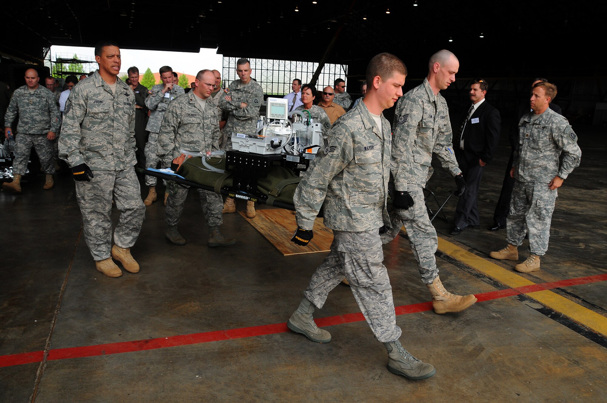 SCOTT AIR FORCE BASE, Ill. -- Master Sgt. Bryan Jordan, Maj. Mark Chojnackl, Senior Airman Dustin Walker and Tech. Sgt. Charles O'Quin, all from the 375th Aeromedical Evacuation Squadron, carry a simulated critical care patient onto an Illinois Air National Guard C-130. (U.S. Air Force photo/Bob Fehringer) 