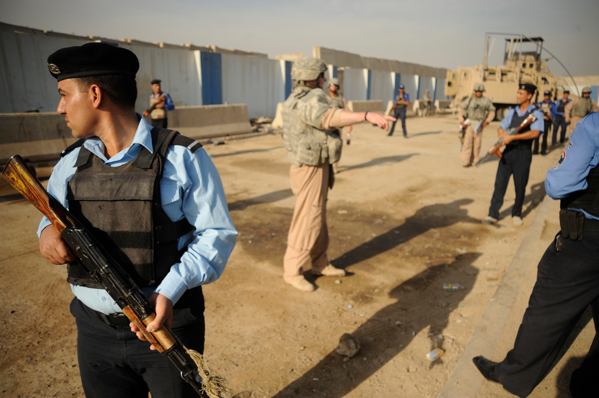 Center U.S. Air Force Senior Airman George Brodish, a Security Forces Airman assigned to the 732nd Expeditionary Security Forces Squadron Det. 3, advises and trains Iraqi Police May 11, 2009, in Baghdad. Airman Brodish is deployed from Ellsworth Air Force Base, S.D. (U.S. Air Force Photo by Staff Sgt. Shawn Weismiller)