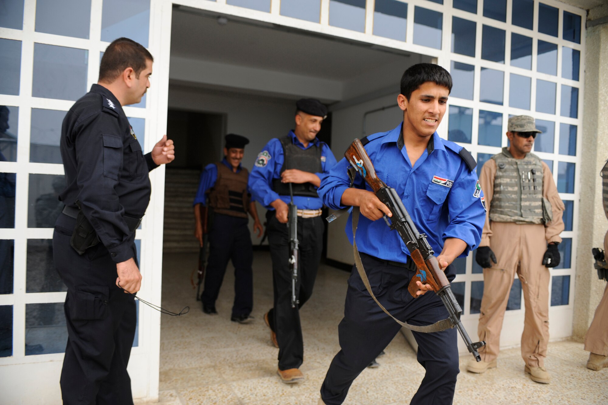 Iraqi Policemen run to formation as U.S. Air Force Airmen of the 732nd Expeditionary Security Forces Squadron Det. 3 conduct a training session May 10, 2009, in Baghdad. U.S. Air Force Security Forces Airmen are assigned to Forward Operating Base Falcon to train local Iraqi Police. These Airmen are responsible for numerous Iraqi Police Stations within Southern Baghdad. Detachment 3 is made up of Airmen from over fifty bases throughout the United States, Europe and Asia.   (U.S. Air Force Photo by Staff Sgt. Shawn Weismiller)