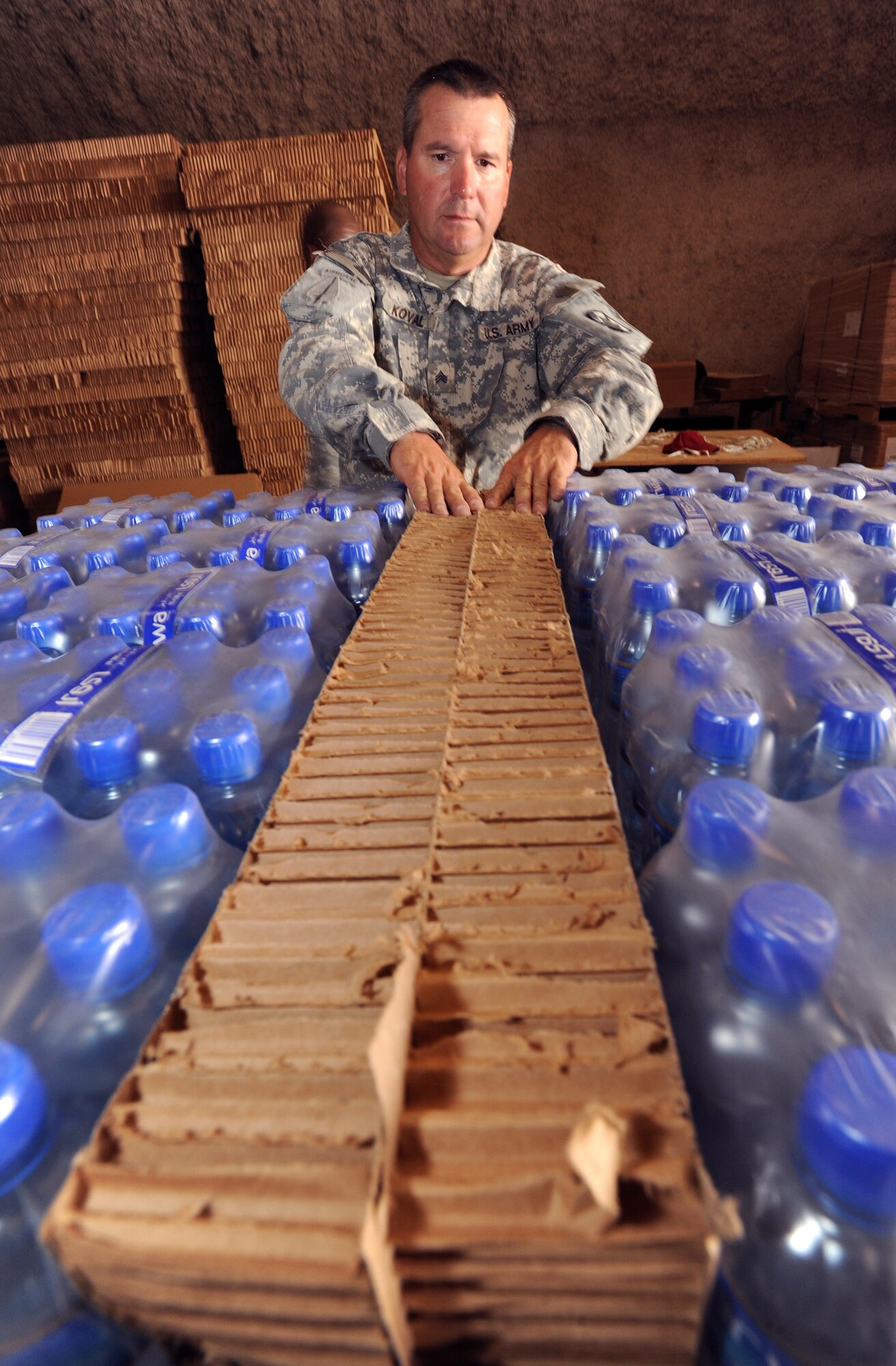 U.S. Army Sergeant Karol Koval separates water packs on a supply pallet with Energy Dissipating Material in preparation for an airdrop, June 3, 2009, in an undisclosed location in Southwest Asia.  The EDM allows the pallet to fall from high and low altitudes by parachute and land safely without damaging the contents within.  Riggers provide vital supplies to servicemembers throughout the U.S. Central Command's area of responsibility by preparing these supply pallets for air-drop delivery by C-17 Globemaster III aircraft.  Sergeant Koval is native to Fayetteville N.C. and is deployed from Fort Bragg, N.C. in support of Operations Iraqi and Enduring Freedom and Combined Joint Task Force - Horn of Africa.  (U.S. Air Force Photo by Staff Sgt. Joshua Garcia/released)