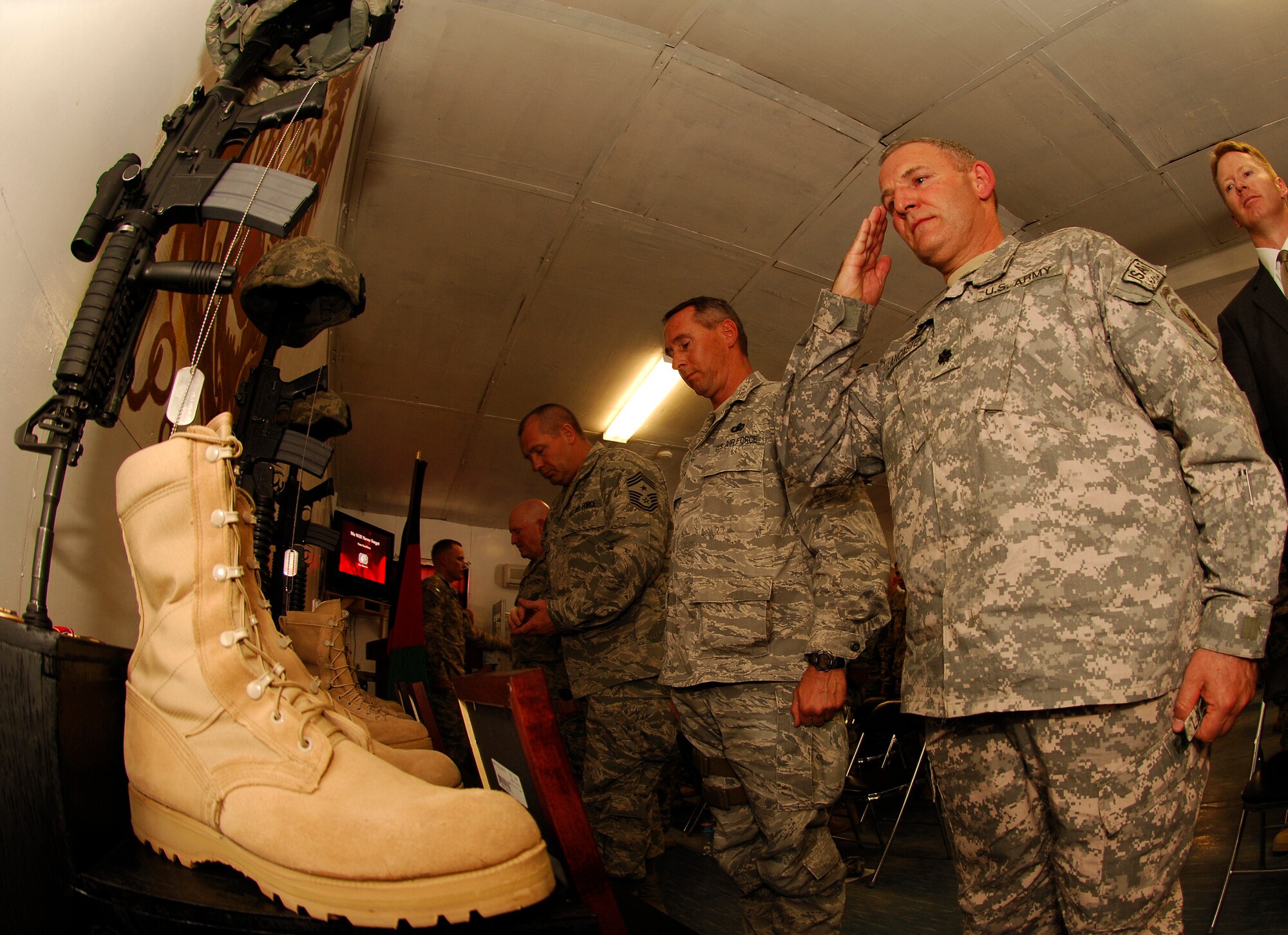 BAGRAM AIR FIELD, Afghanistan -- Army Lt. Col. Steve Lancaster, the new commander for the Panjshir Provincial Reconstruction Team, renders a salute to fallen comrade Lt. Col. Mark Stratton during a memorial ceremony at Forward Operating Base Lion in Panjshir Province May 31. Four members of the reconstruction team were killed May 26 when their convoy vehicle was struck by a suicide car bomber. More than 75 American servicemembers and Afghan leaders paid tribute to Air Force Lt. Col. Mark Stratton, the team's commander, Army Master Sgt. Blue Rowe, civil affairs NCO, Air Force Senior Airman Ashton Goodman, vehicle operator, and Abdul Samad, the unit’s Afghan legal advisor. (Air Force/Staff Sgt. Jason Lake)