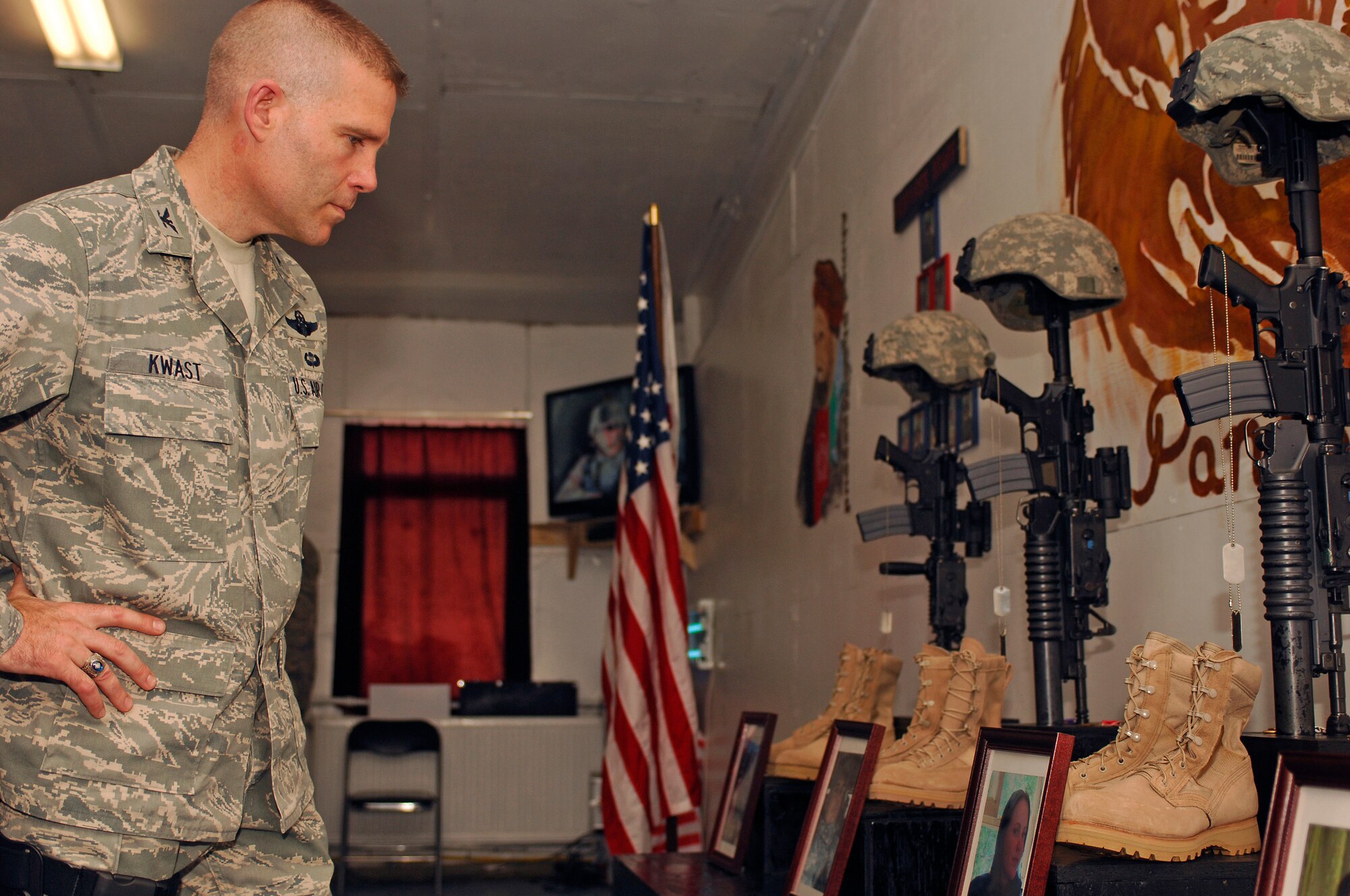 BAGRAM AIR FIELD, Afghanistan -- Col. Steven Kwast, 455th Air Expeditionary Wing commander, takes a moment to honor fallen members of the Panjshir Provincial Reconstruction Team during a memorial ceremony at Forward Operating Base Lion May 31. More than 75 American servicemembers and Afghan leaders attended the ceremony to honor Lt. Col. Mark Stratton, Master Sgt. Blue Rowe, Senior Airman Ashton Goodman and Abdul Samad who were killled when their convoy vehicle was struck by a suicide car bomber May 26.  (Air Force/Staff Sgt. Jason Lake)