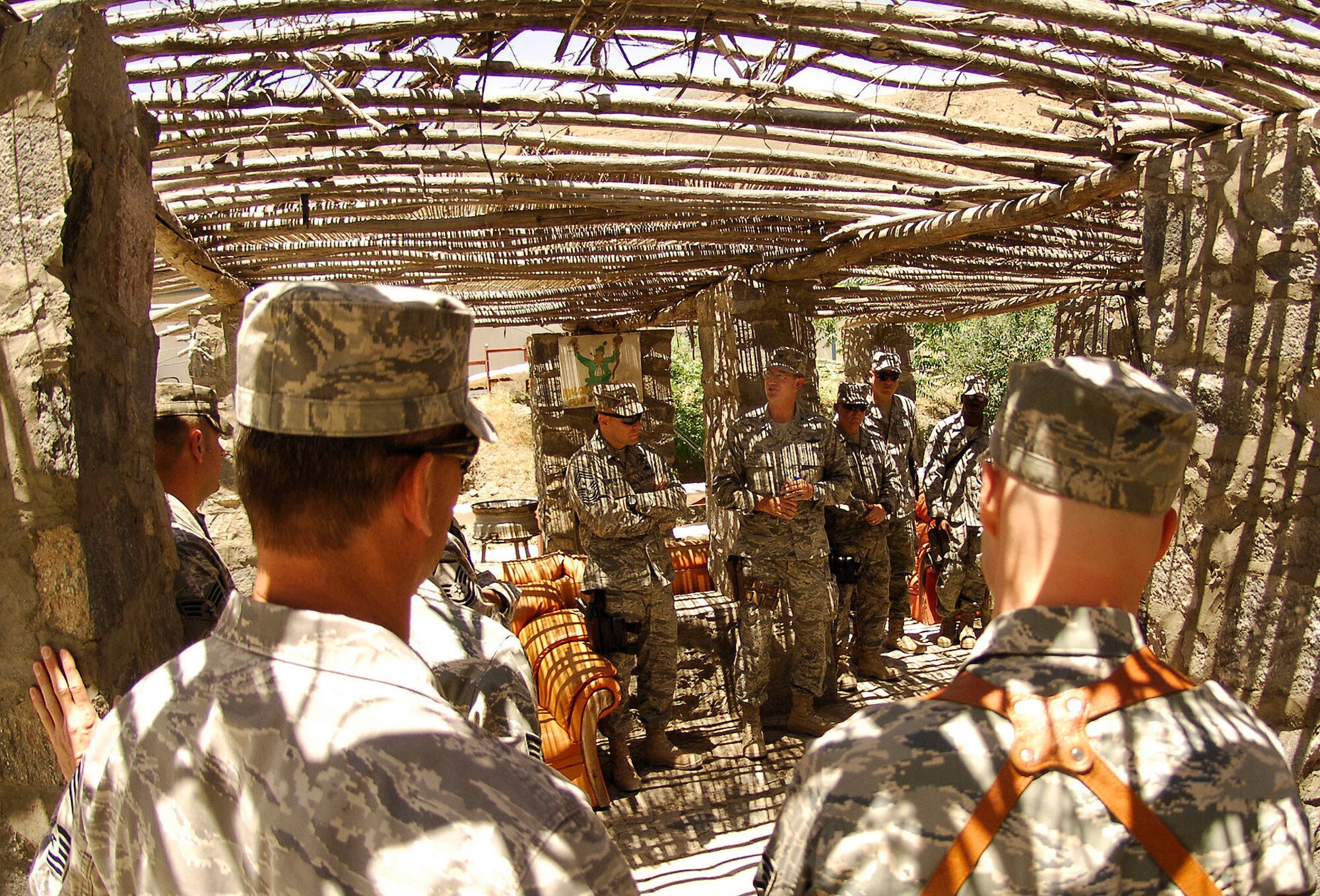 BAGRAM AIR FIELD, Afghanistan -- (Center) Chief Master Sgt. Dennis Vannorsdall, 455th Air Expeditionary Wing command chief master sergeant, and Col. James Reed, 755th Air Expeditionary Group commander, talk with Airmen from the Panjshir Provincial Reconstruction Team shortly before a memorial ceremony for four of their fallen comrades May 31. Several Air Force leaders, including Col. Steven Kwast, 455th Air Expeditionary Wing commander, held an Airman's Call before a ceremony that paid tribute to Air Force Lt. Col. Mark Stratton, Army Master Sgt. Blue Rowe, Air Force Senior Airman Ashton Goodman and the unit's legal advisor, Abdul Samad. The four were killed when their convoy vehicle was hit by a suicide car bomber May 26. More than 75 American and Afghan comrades paid one final tribute to their fallen teammates. (Air Force/Staff Sgt. Jason Lake)
