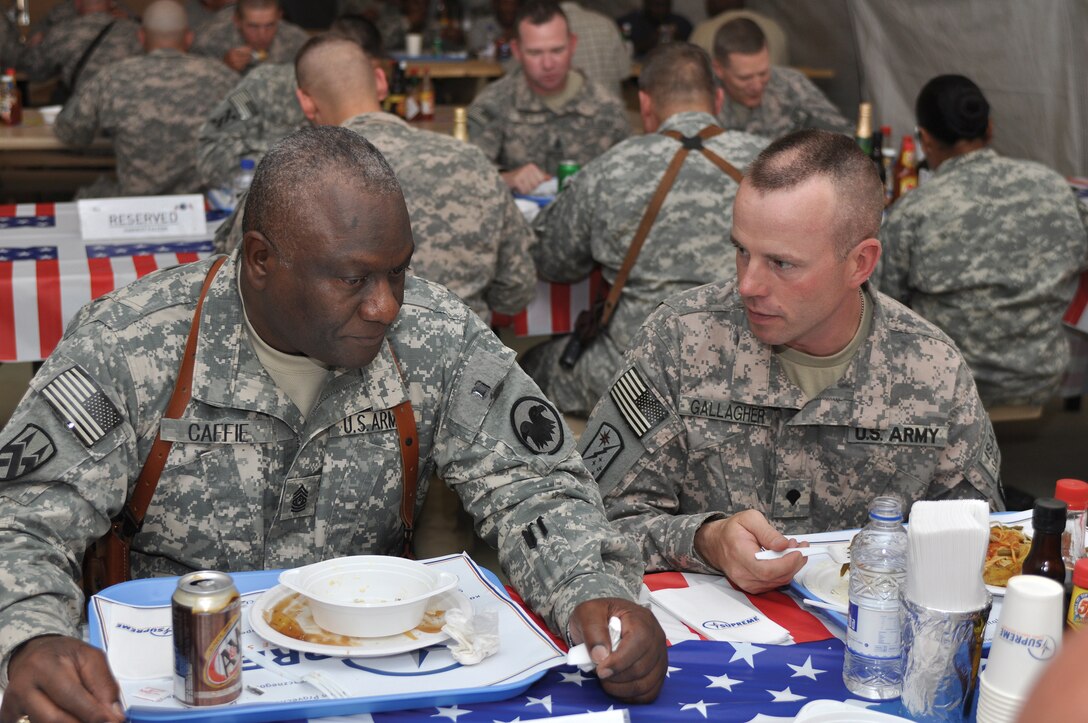 U.S. Army Command Sgt. Maj. Leon E. Caffie, the senior enlisted soldier of the U.S. Army Reserve, visits with Spc. Timothy Gallagher of the 286th Combat Support Sustainment Battalion while eating lunch with troops at the Harvest Falcon Dining Facility on Kandahar Airfield, Afghanistan, June 4, 2009. Caffie accompanied U.S. Army Lt. Gen. Jack C. Stultz Jr., commanding general, U.S. Army Reserve Command, on a visit to reservists assigned to the Joint Sustainment Command-Afghanistan.